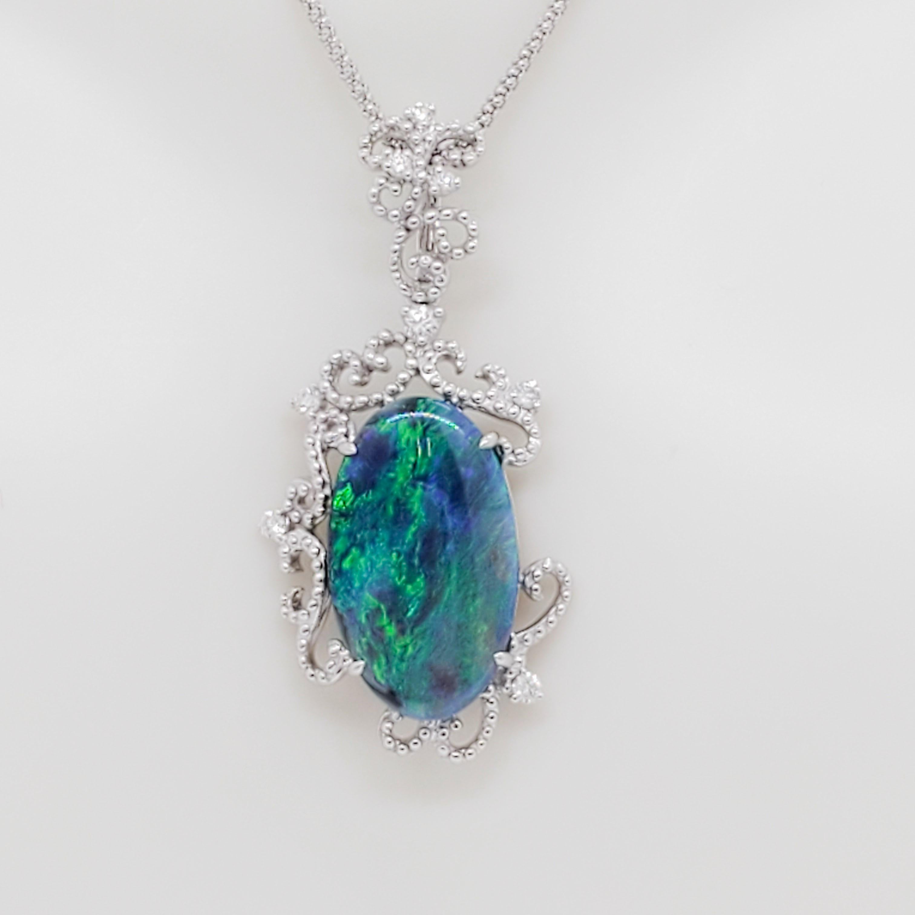 Gorgeous 5.96 ct. black opal oval with 0.22 ct. white diamond rounds.  Handmade in 18k white gold.  Chain is 18