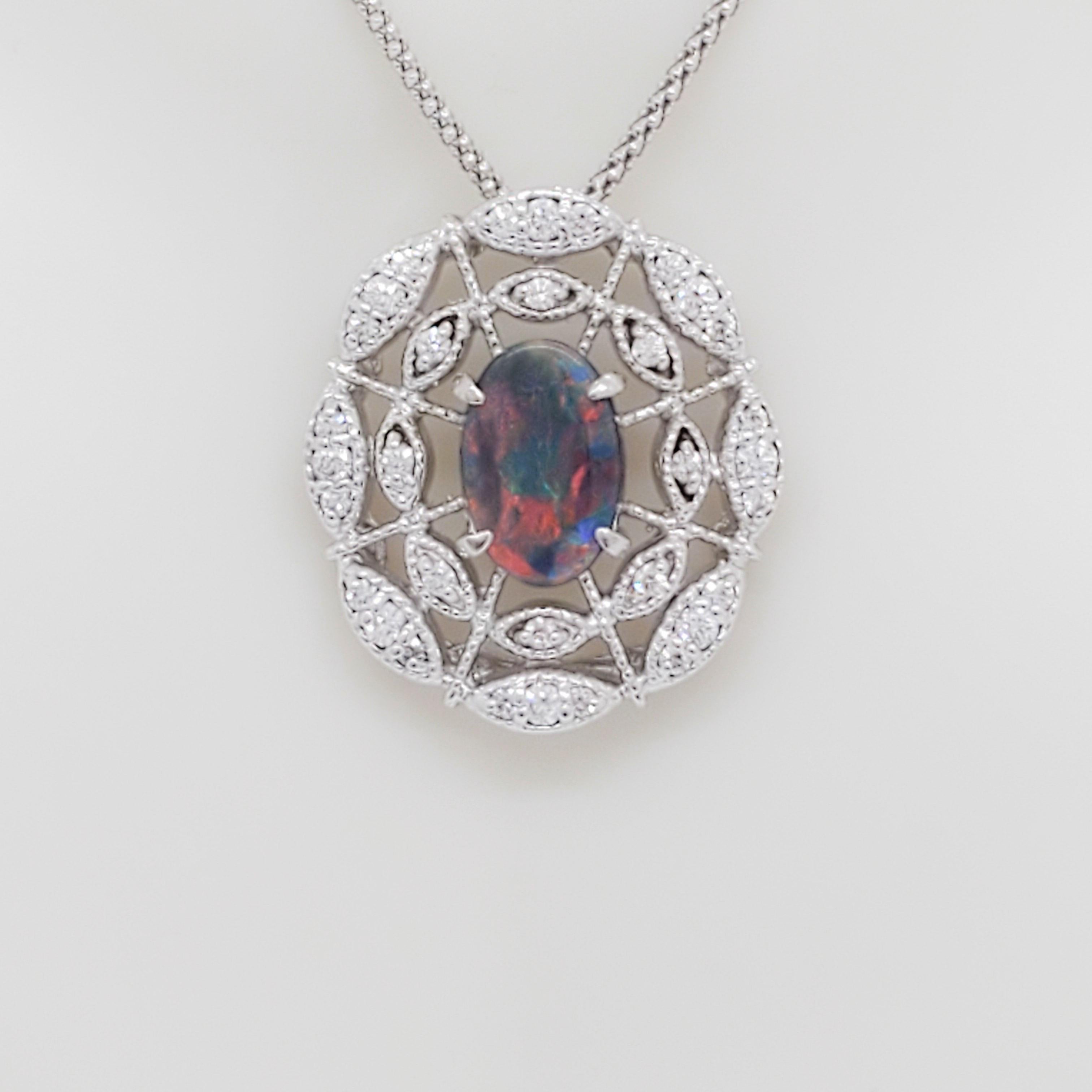 Gorgeous 0.91 ct. black opal ova with 0.52 ct. good quality white diamond rounds.  Handmade in 18k white gold.  Chain is 18