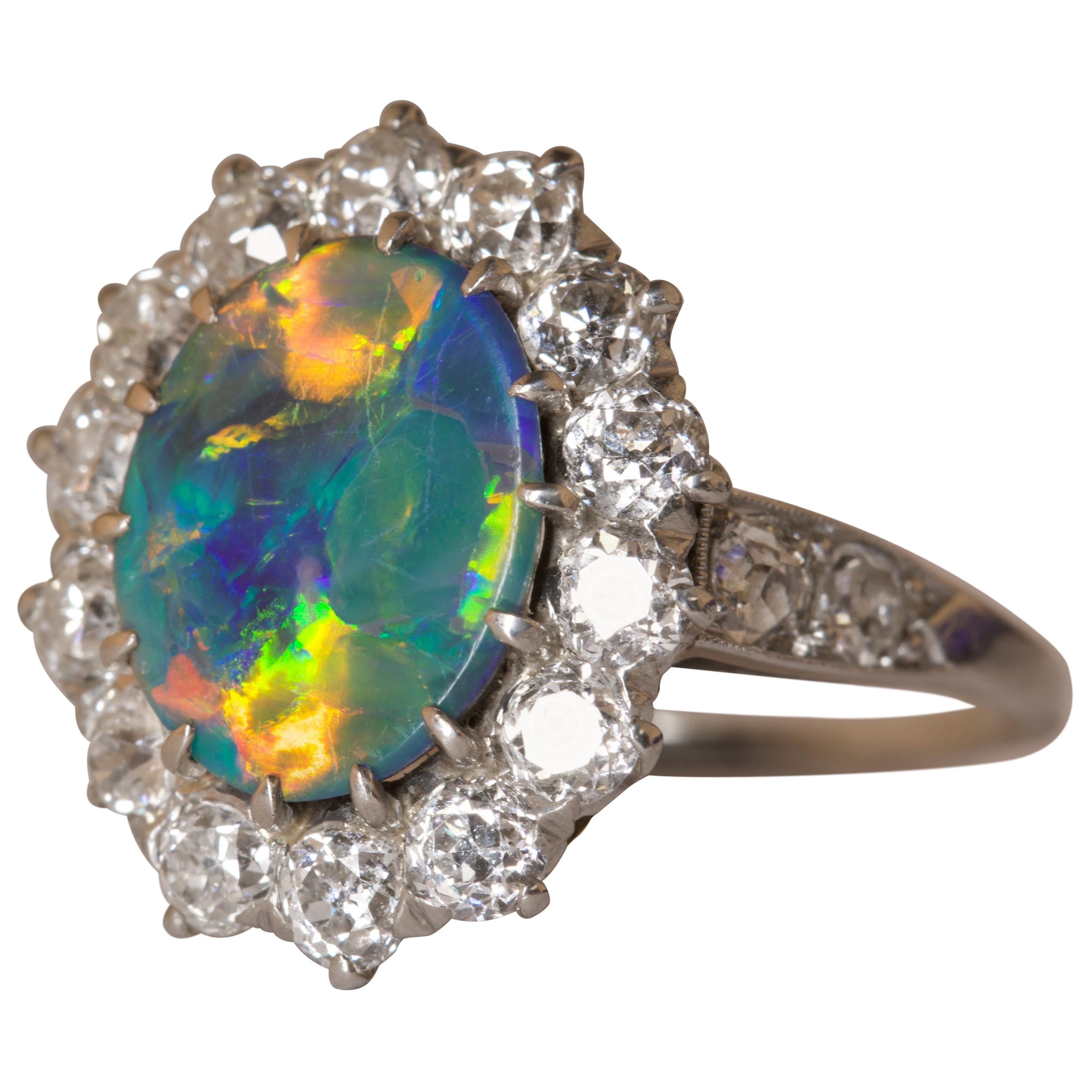 You could be gazing into a galaxy in the sky, but instead you have the added bonus of carrying this around proudly on your finger and losing yourself in it whenever you wish to escape the everyday normalities. 

This mesmerising black opal measuring