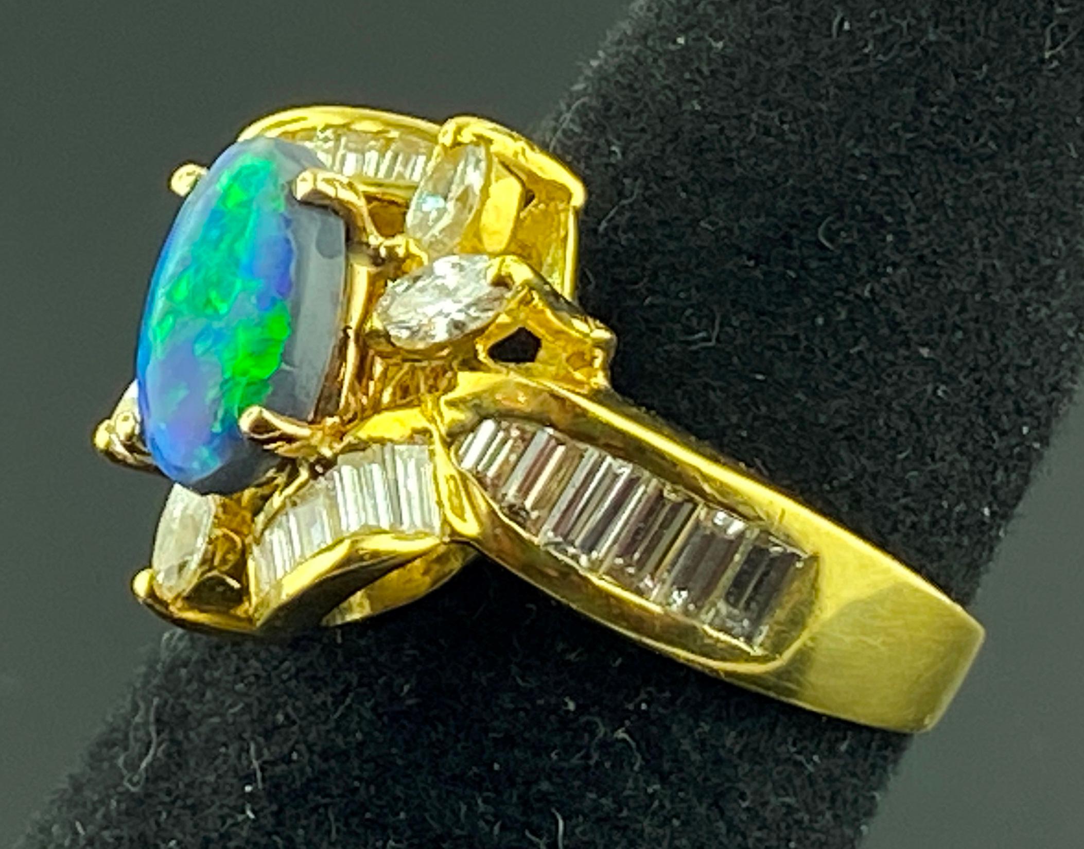 Oval Cut Black Opal and Diamond Ring in 18 Karat Yellow Gold