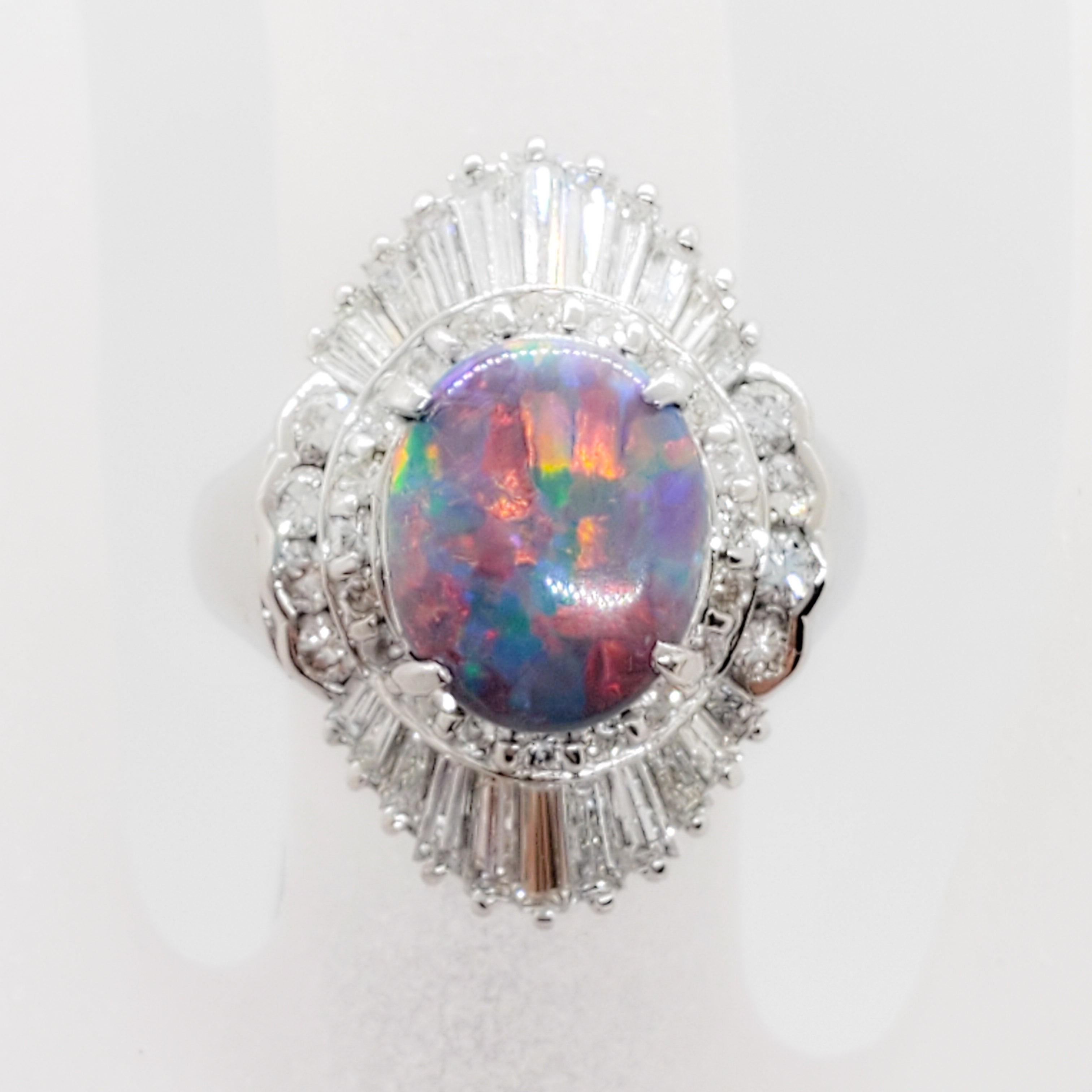 Gorgeous estate black opal ring with 1.47 cts of good quality white diamonds and a 1.97 ct. black opal oval.  This ring is handmade in platinum in a size 6.  Really pretty colors running through this opal.  Perfect for day or night.