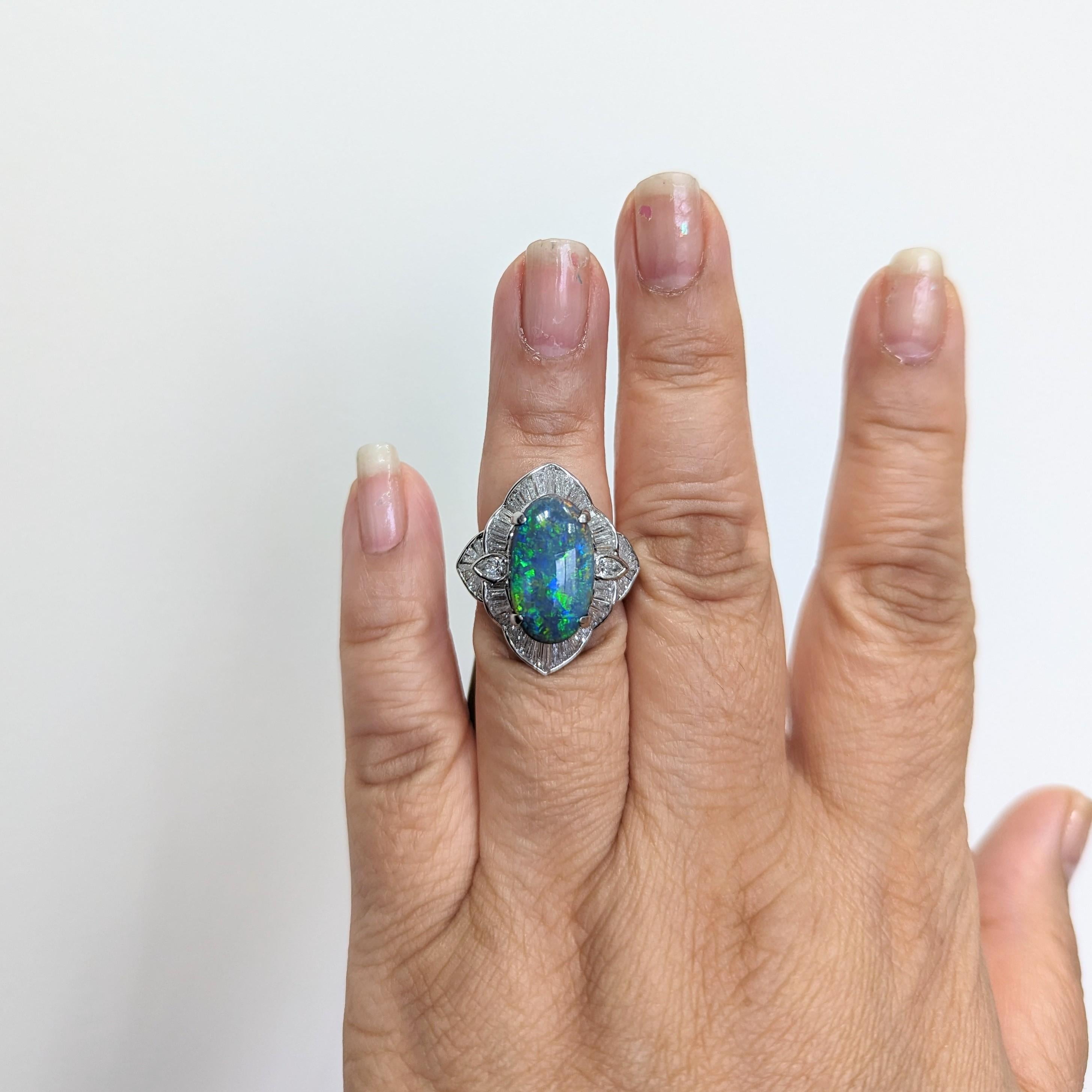 Beautiful 5.37 ct. black opal oval with 2.03 ct. good quality white diamond baguettes and pear shapes.  Handmade in platinum.  Ring size 5.75.