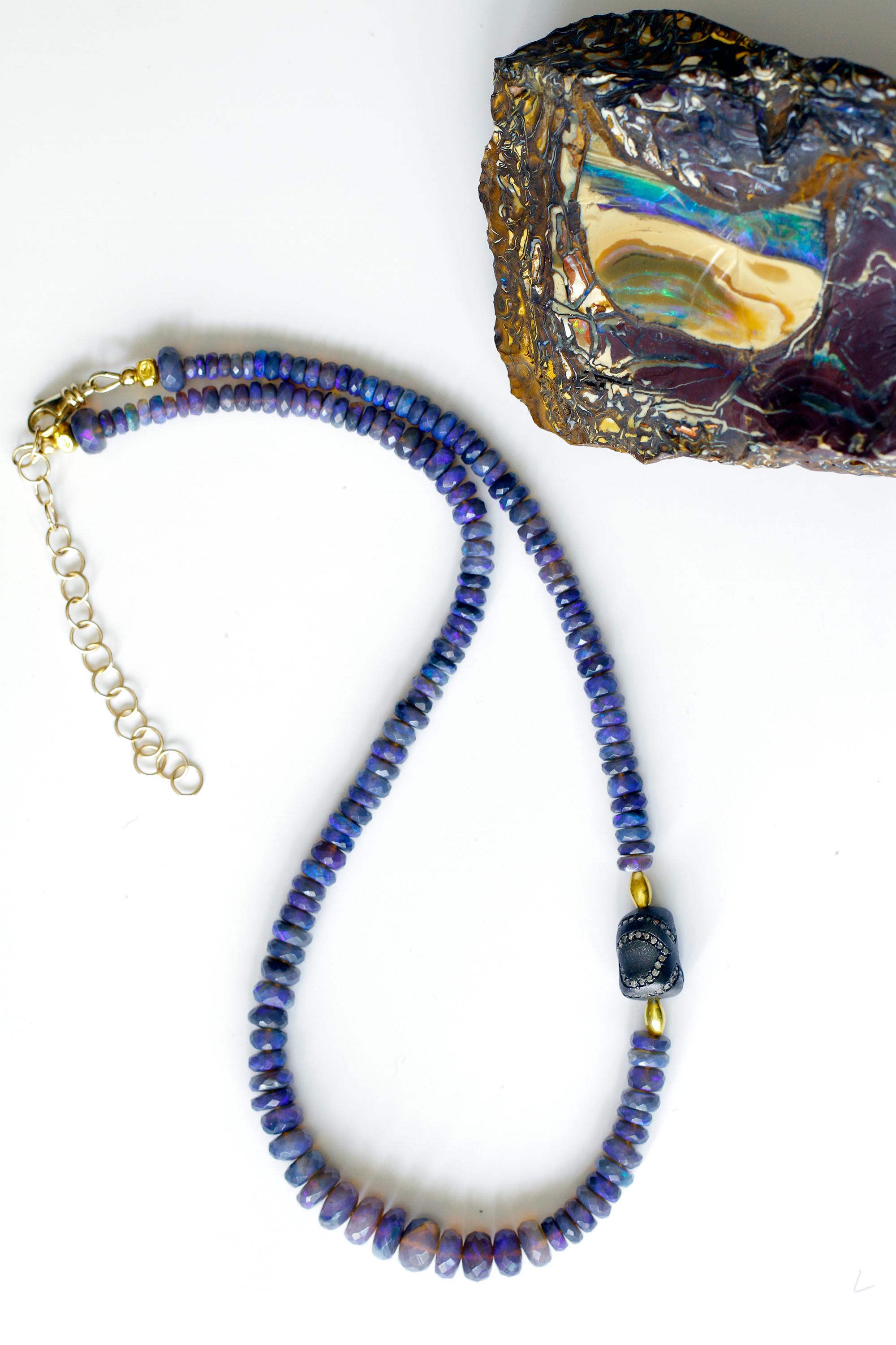 A beautiful strand of black opal beads, purplish blue in color with a diamond encrusted oxidized bead and 18k gold beads.  Black opal comes from New South Wales, primarily from Lightening Ridge.  Black manganese is its matrix. Where ironstone is