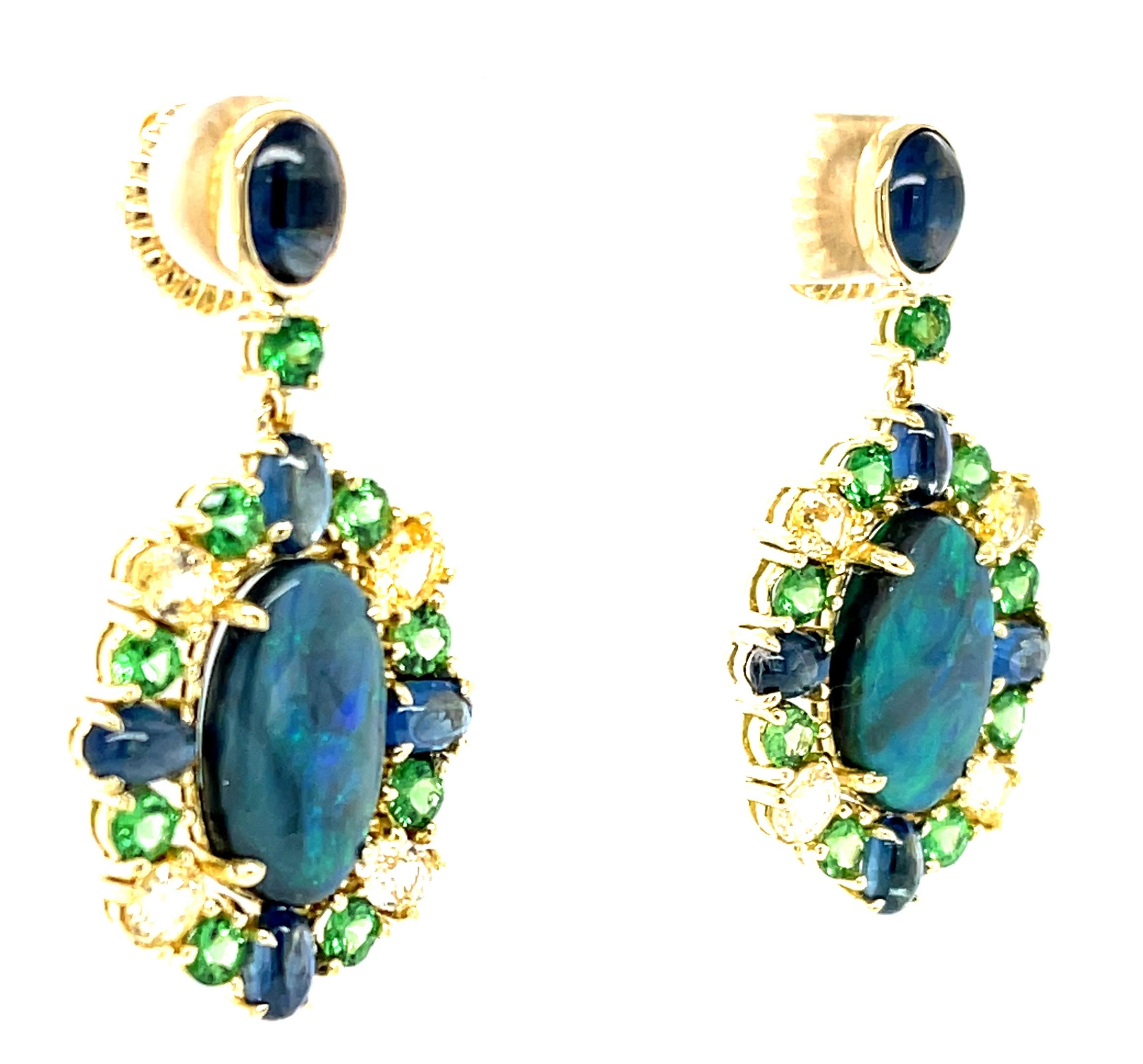 These dazzling gemstone earrings are true originals, featuring fine black opals framed with a spectacular gemstone palette of blues and greens! The black opals have an elegant, elongated shape and striking play-of-color with flashes of electric