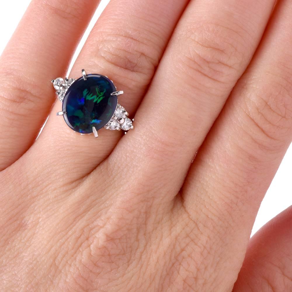 This estate platinum ring crafted in platinum exposes a highly coveted genuine black opal of ovular format, displaying the quintessential play of colors inherent in opals. The ring weighs 8.5 grams and the eye-catching black opal weighing 4.01carats