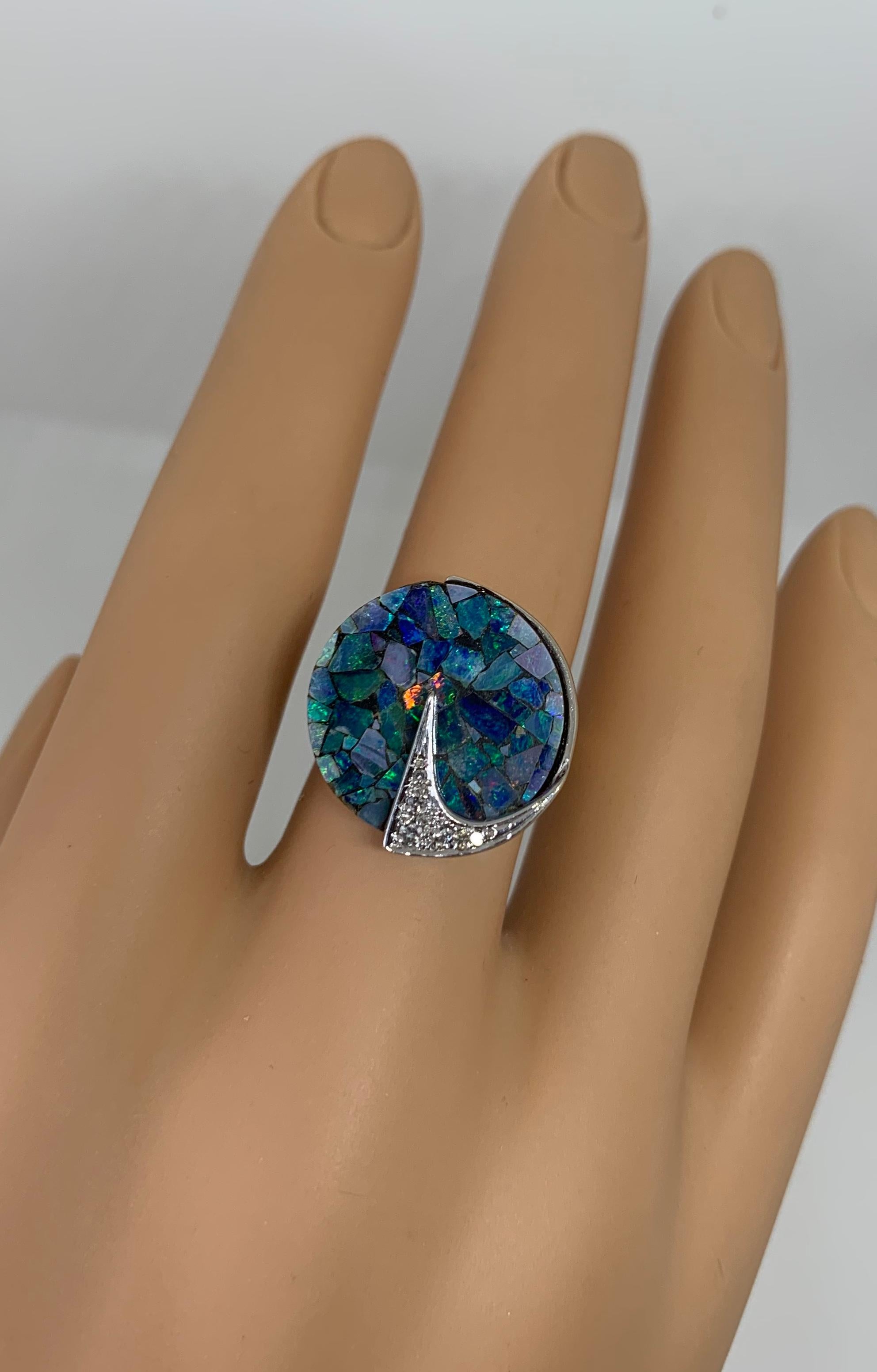 THIS IS A WONDERFUL MID-CENTURY MODERNIST EAMES ERA BLACK OPAL AND DIAMOND RING IN 14K YELLOW AND WHITE GOLD WITH A STUNNING MATRIX DESIGN.
The effect of the gorgeous natural black opals set in a circular matrix design is stunning.  The opals are