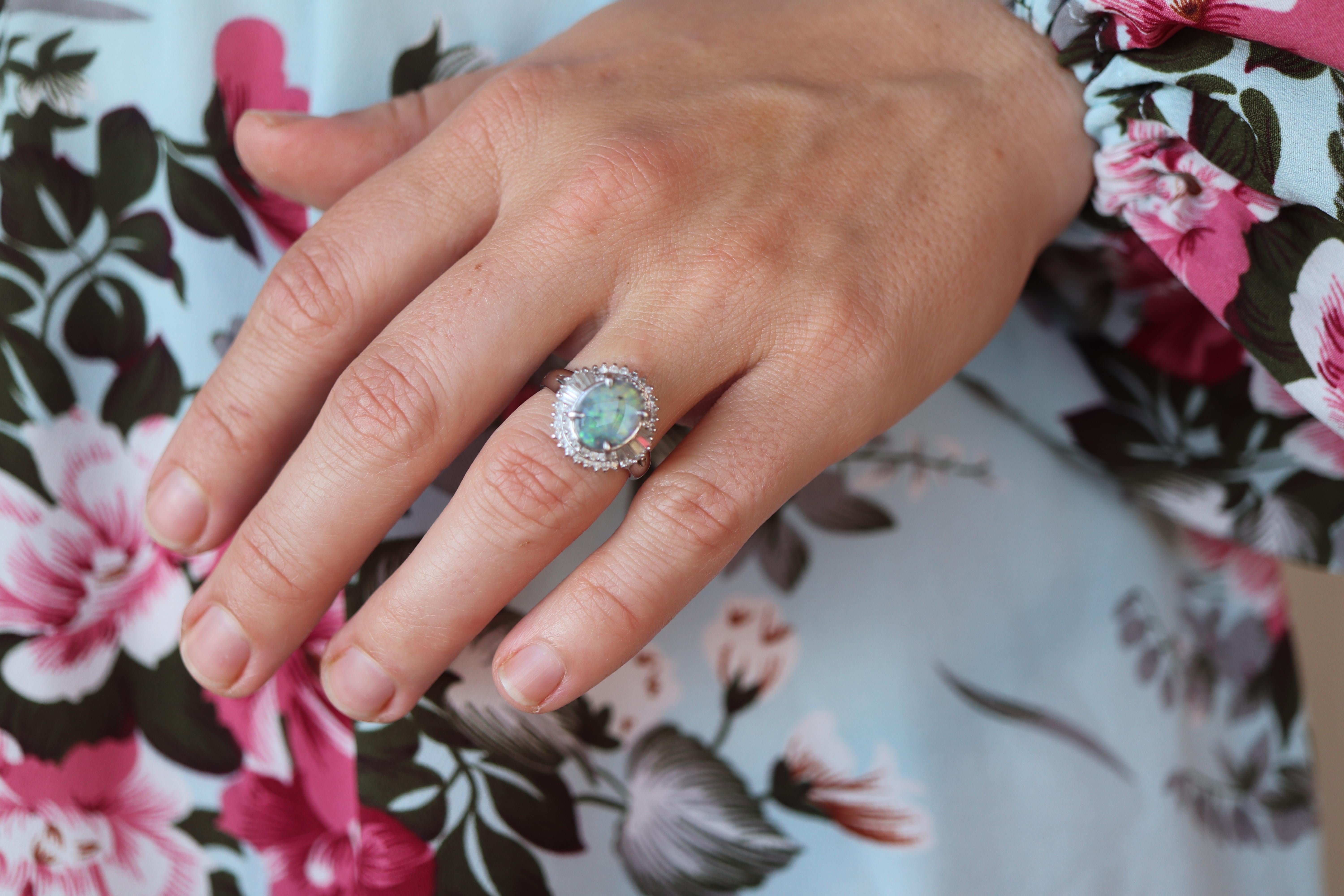 Stunning Australian Black Opal Oval Cabochon

Halo design ring with Diamond accents.

Ballerina Design.

Stunning for any occasion - Perfect Engagement or Promise ring.

Appraised at $3100. Appraisal is included.

Platinum Pt850

Details:
10.34mm by