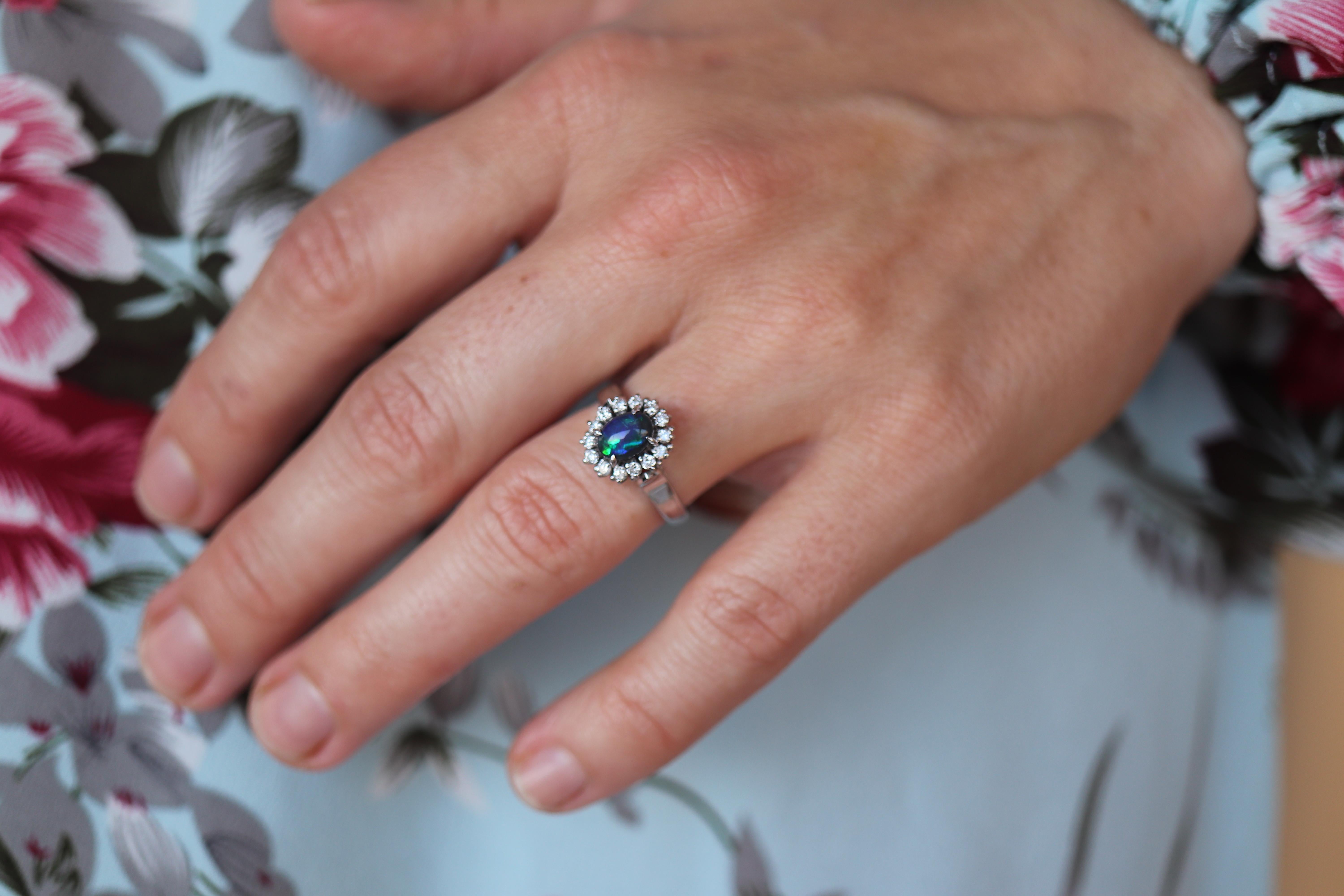 Stunning Australian Black Opal Oval Cabochon

Halo design ring with Diamond accents.

Ballerina Design.

Stunning for any occasion - Perfect Engagement or Promise ring.

Appraised at $2700. Appraisal is included.

Platinum Pt900

Details:
7.18mm by