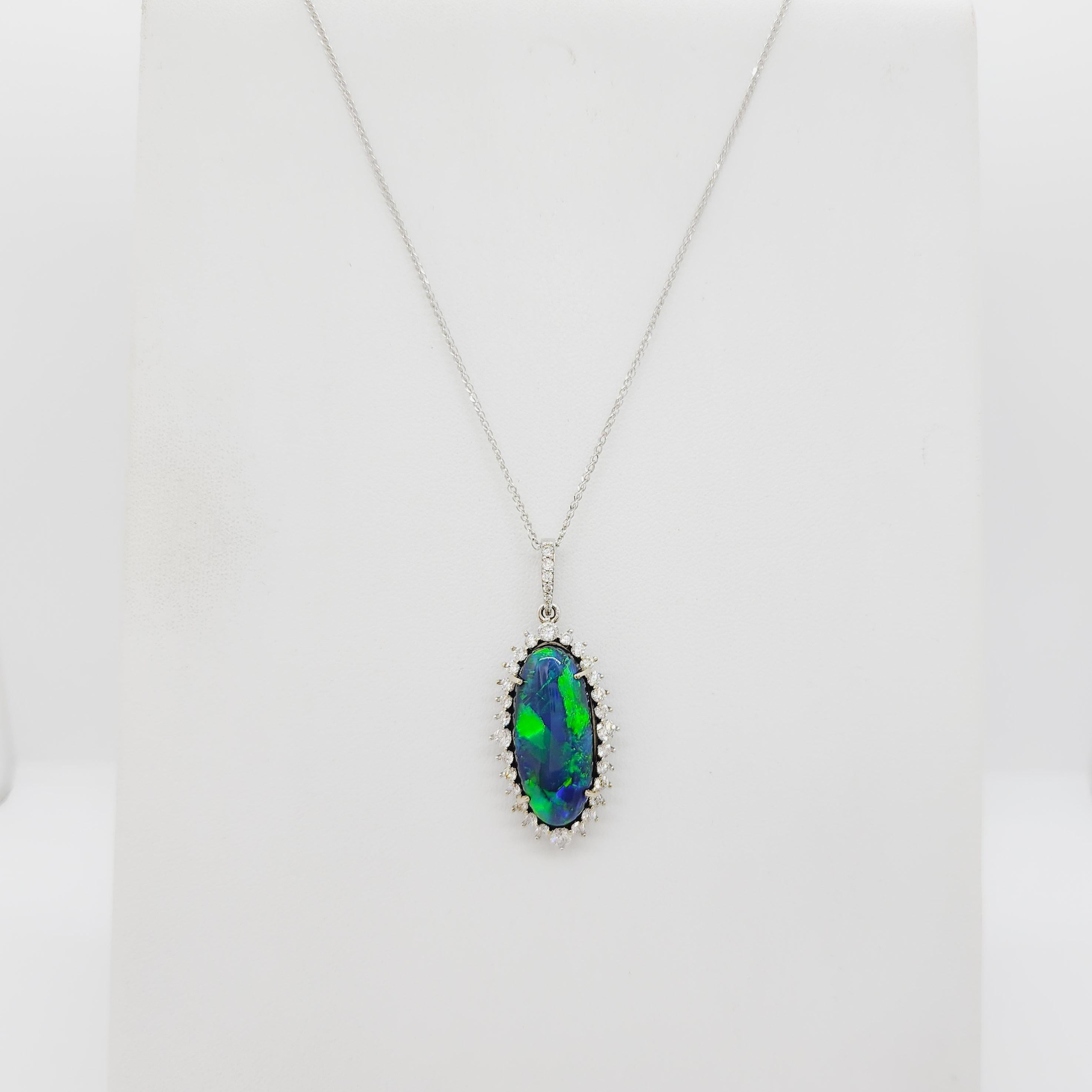 Beautiful 10.57 ct. black opal oval cabochon with 1.24 ct. good quality white diamond rounds.  Handmade in 18k white gold.  Length is 18