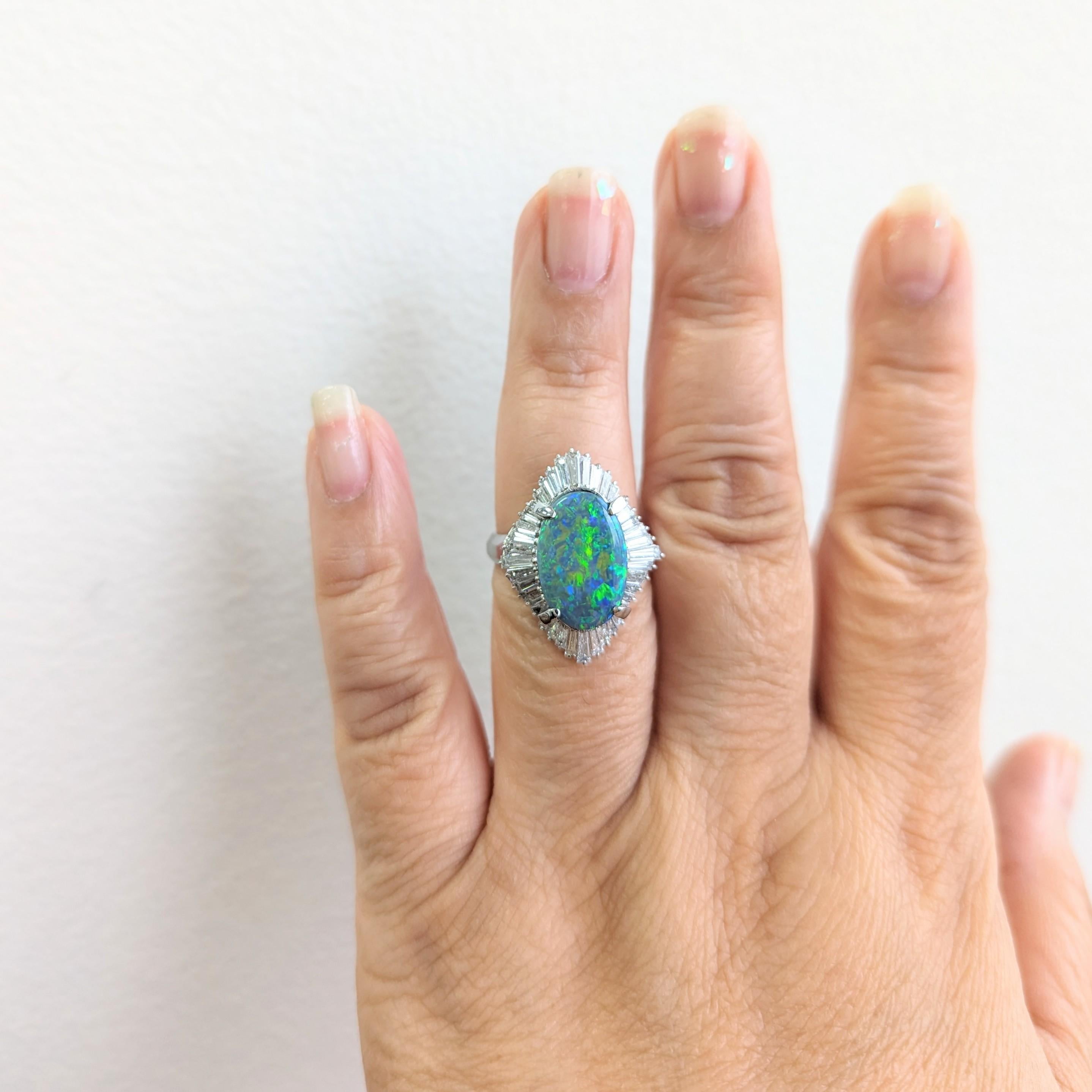 Beautiful 3.14 ct. black opal oval with 1.64 ct. good quality white diamond baguettes.  Handmade in platinum.  Ring size 7.5.