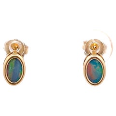 Black Opal Oval Stud Earrings in 14k Yellow Gold