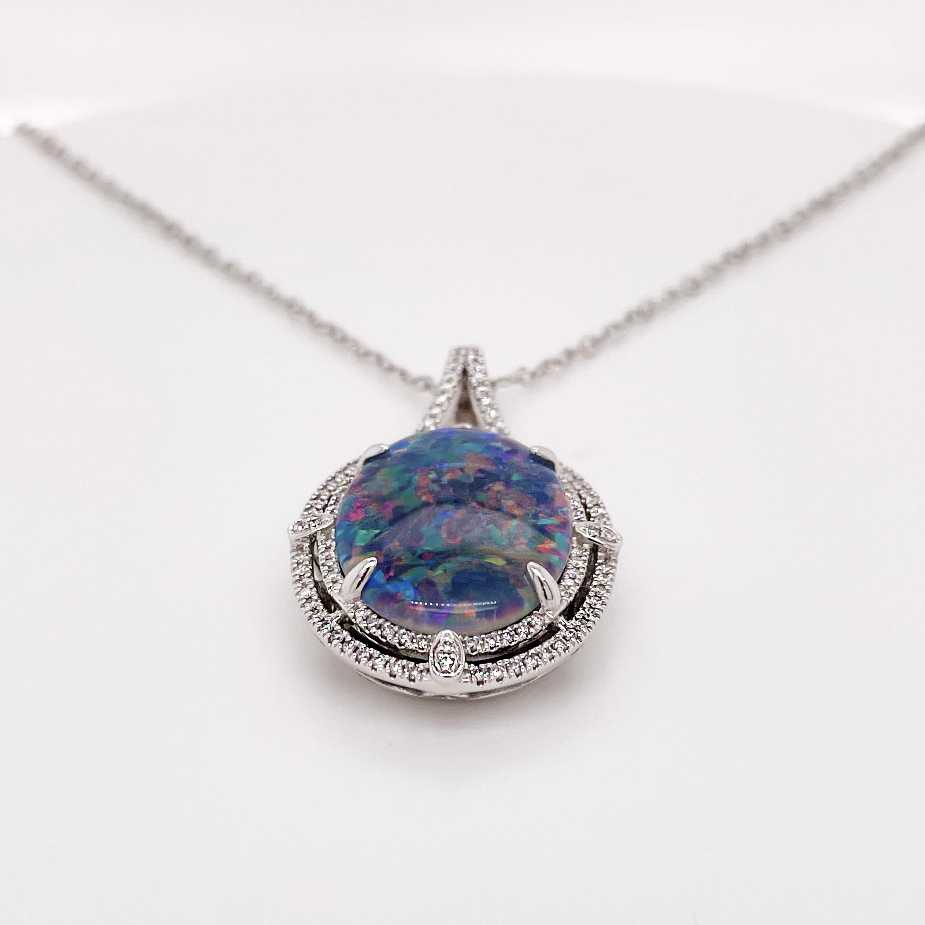 Black Australian Opal is rare and it is even rarer in this size-9 carats! It is surrounded by 84 gorgeous diamonds.  When you look in this opal you will see an overall blue color with a flash of green, pink and purple. The necklace comes with the 14