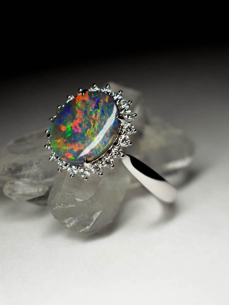 Placed in solid 18k white gold this stunning, absolutely beautiful gem from the famous black opal mining town of Lightning Ridge Australia (Home of the Black Opal) shows 5 out of 5 bright coloring! 

With flashing colours of wonderful red, blue and