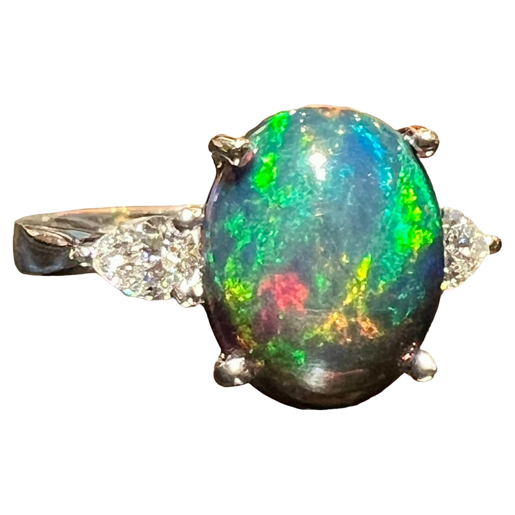 Black Opal ring surrounded by 2 pears 18 carat white gold diamond For Sale