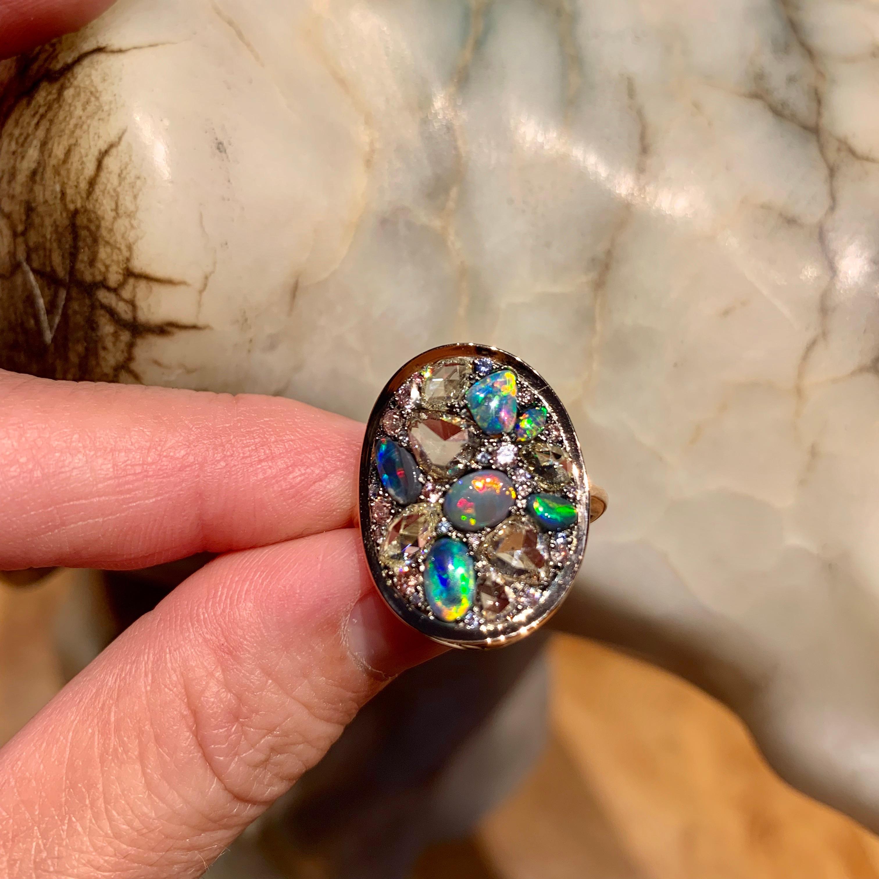 One of a kind ring in 18K rose gold 6,7 g & blackened sterling silver (The stones are set on silver to create a black background for the stones)
Black Lightning Ridge opal cabochons 1,53 ct., rose-cut diamonds 2,08 ct., fancy pink brilliant-cut
