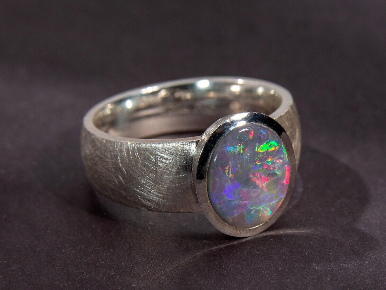 An impressive unisex matte finish silver ring with natural large cabochon-cut Black Opal
opal origin - Australia 
stone measurements - 0.35 х 0.43 in / 9 х 11 mm
ring weight - 7.19 grams
ring size - 8.5 US