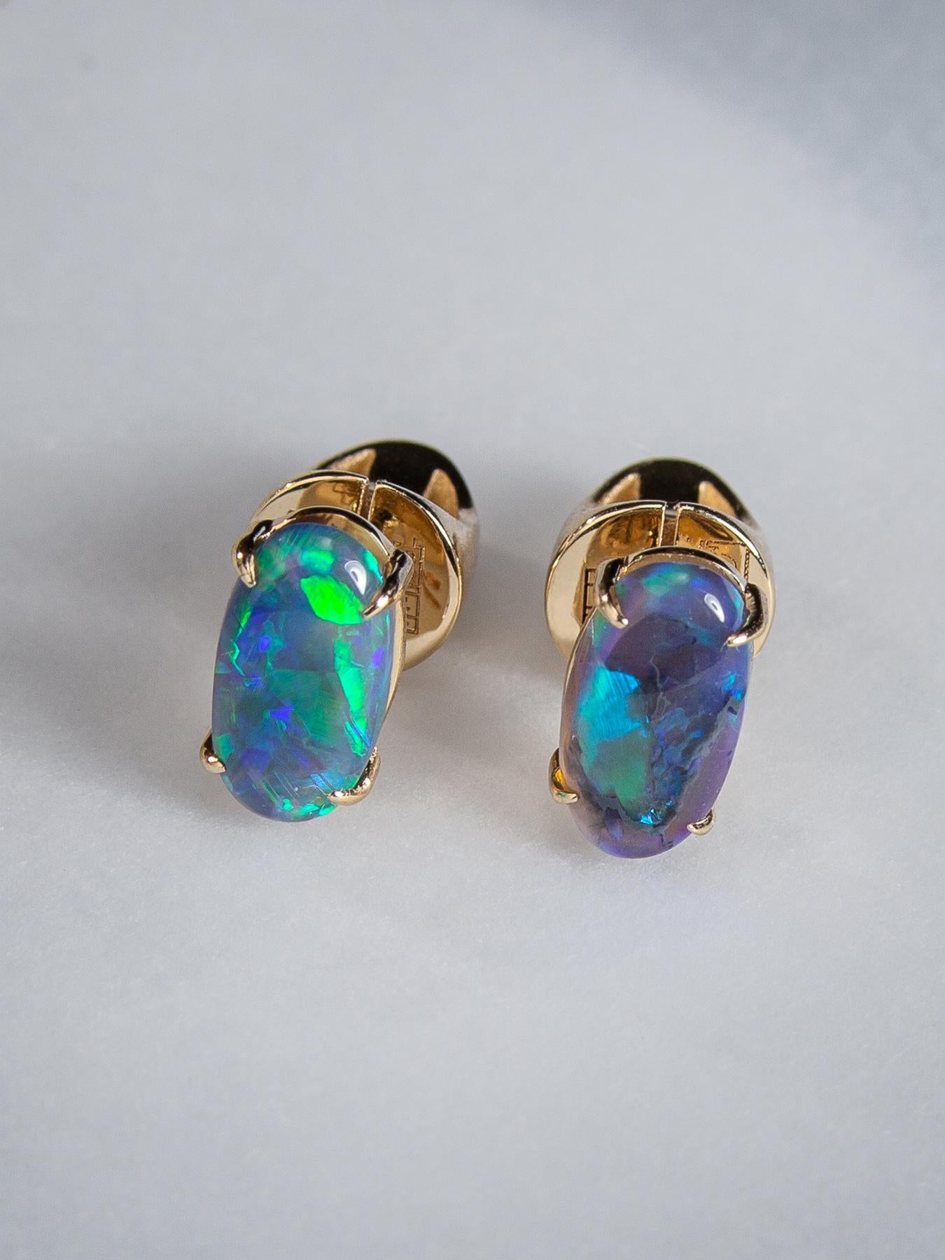 Black opal stud earrings earrings in 14k yellow gold 
opal origin - Australia
stone measurements 0.079 x 0.16 x 0.35 in /  2 х 4 х 9 mm
earrings weight - 2.75 grams
opals weight - 1.35 carats