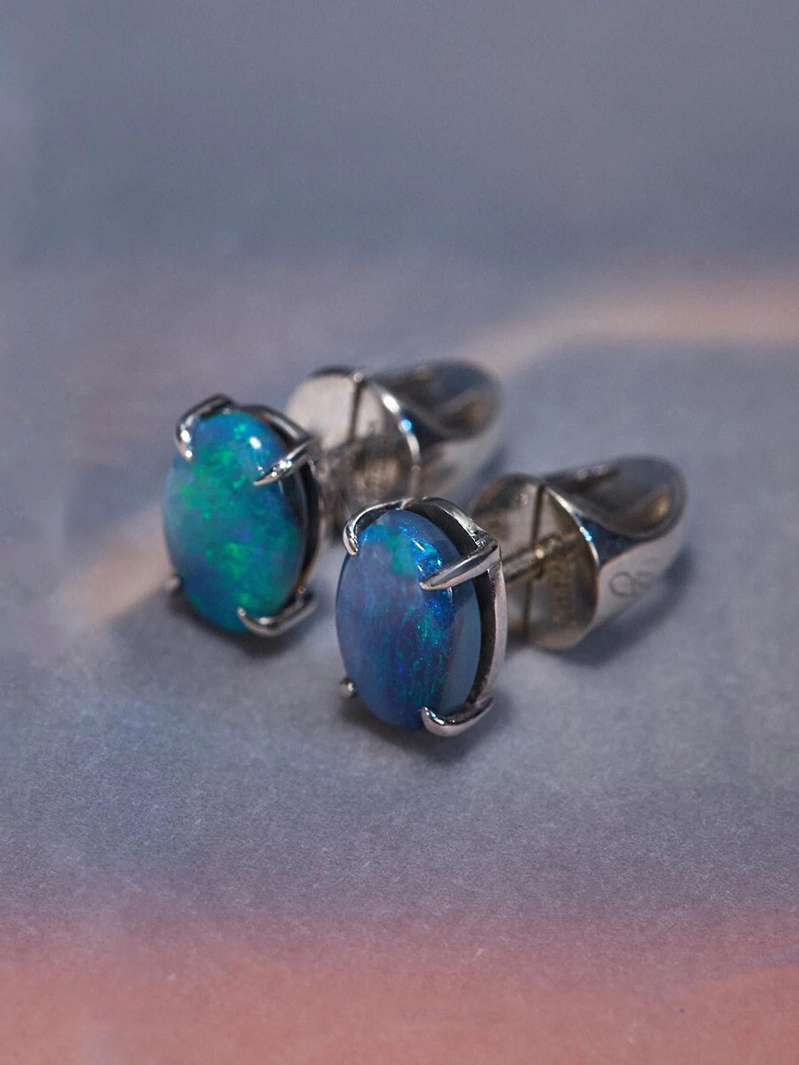 Silver earrings with natural Black Opal 
gemstones origin - Australia
stone measurements 0.24 x 0.31 in / 6 х 8 mm
opal weight - 1.10 carats
earrings weight - 2.21 grams