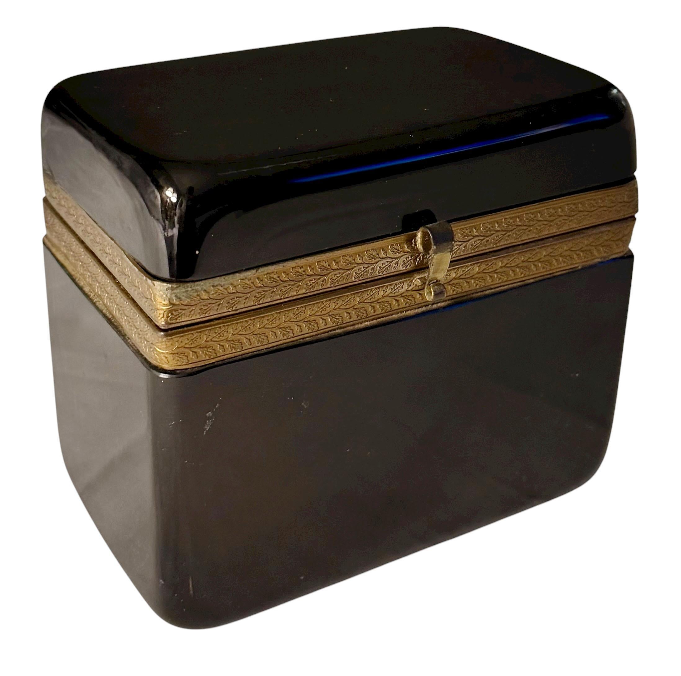 A striking 1940s black German opaline glass box, marked West Germany, showcasing refined craftsmanship and mid 20th century elegance.

This exceptional piece features deep black opaline glass with a luminous finish and a substantial weight that