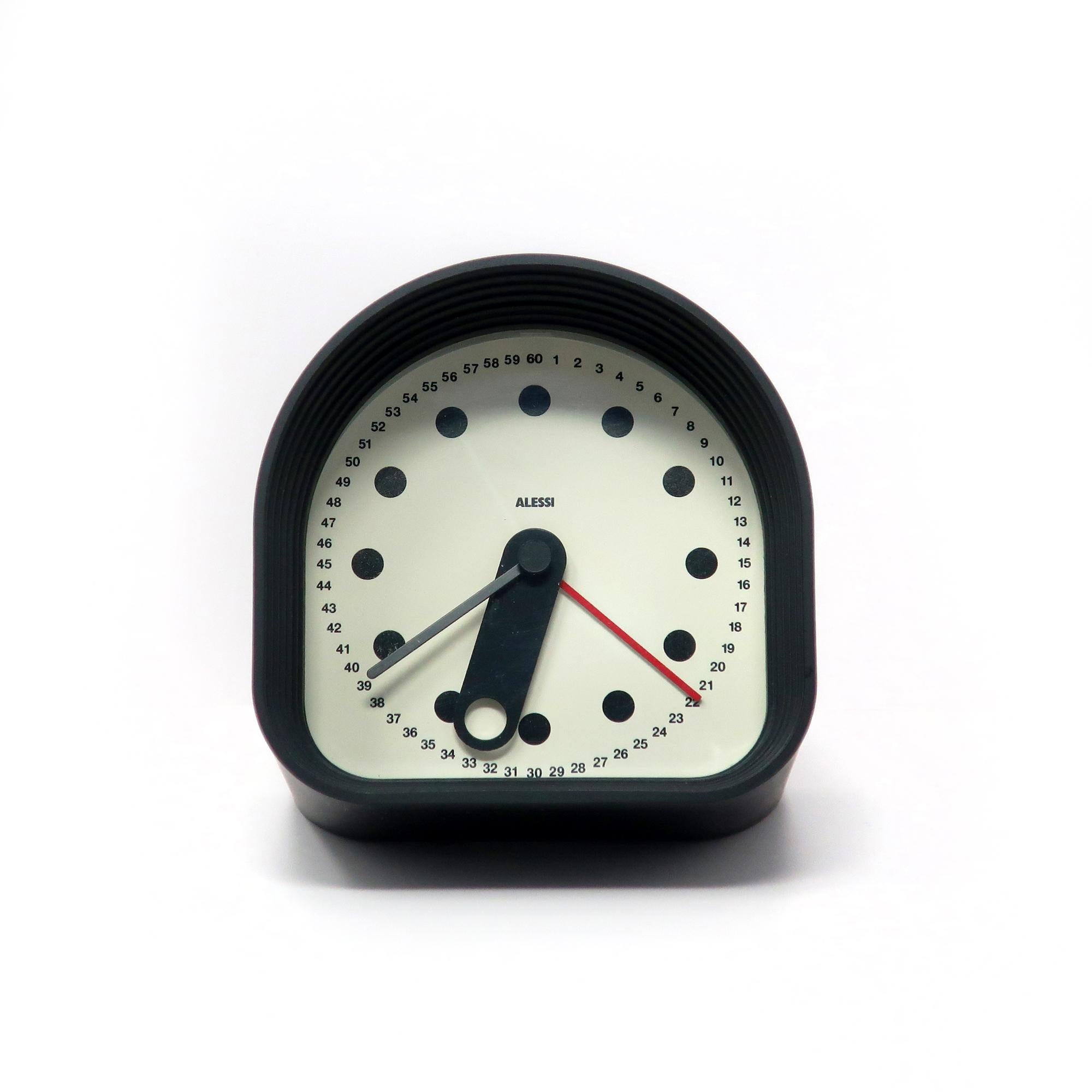 The Optic clock designed by Joe Colombo and produced since the late 1980s by Alessi is a rare and collectible piece of design history.  Imagined by the legendary Italian designer, the clock features a black case, black hands, and white face, and