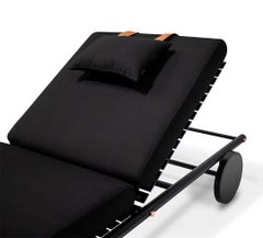 Sleek Outdoor Sunbed with Black Stainless Steel Legs and Copper Trim