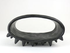 Black Oval Ceramic Sculpture With Many Small Spike Feet