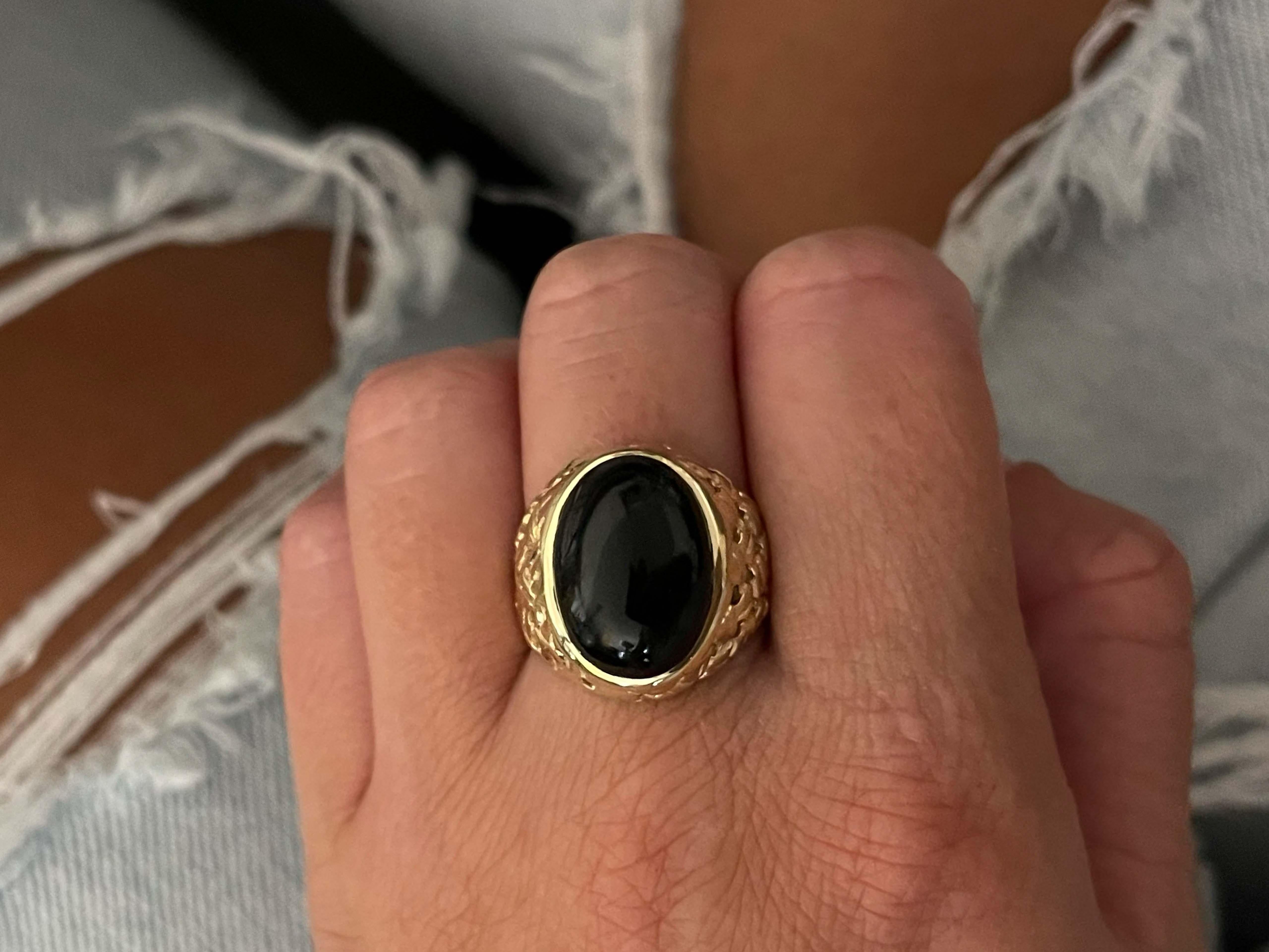 Ring Specifications:

Metal: 14k Yellow Gold

Total Weight: 11.8 Grams

Onyx Measurements: 16.5 mm x 13.2 mm x 5.9 mm 

Onyx Carat Weight: ~9.18 carats

Ring Size: 9 (resizable)

Stamped: 