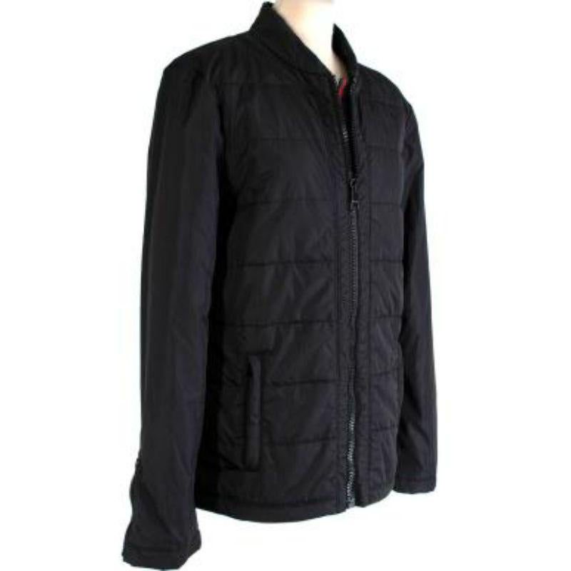 Gucci Black Padded Jacket
 
 -Front zip pockets
 -Gucci web detail 
 -Zip fastening along the front and cuffs 
 -Small collar 
 -Engraved logo on zipper 
 -Slight padding all over 
 
 Material: 
 
 100% Nylon 
 Padding: 
 100% Polyester 
 
 Made in