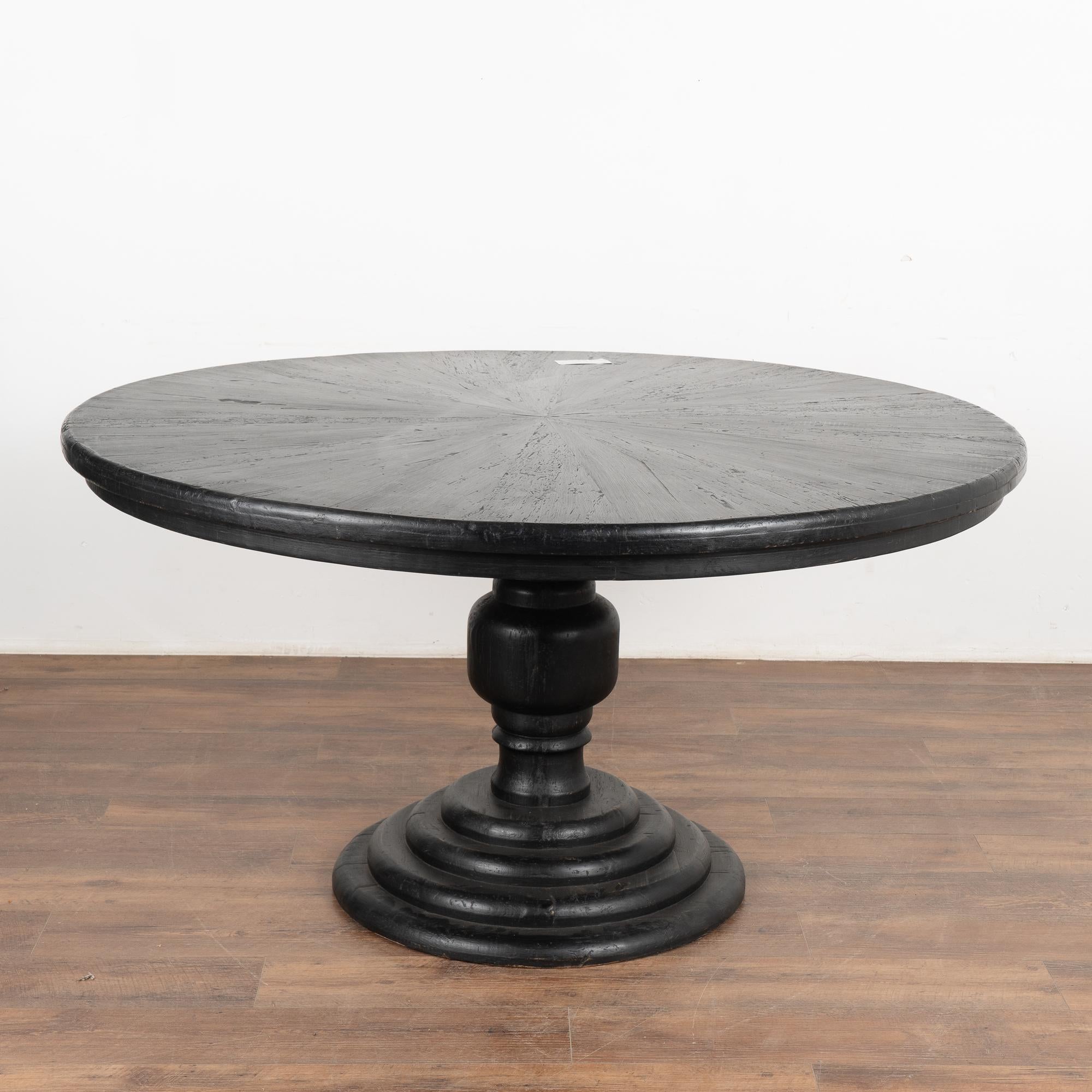 This 5' round pine pedestal table rests on a handsome turned pedestal base.
Professionally painted in black; the wood (likely mesquite) is distressed to create an aged character to this new table.
Solid, level and ready for use. 
Please refer to