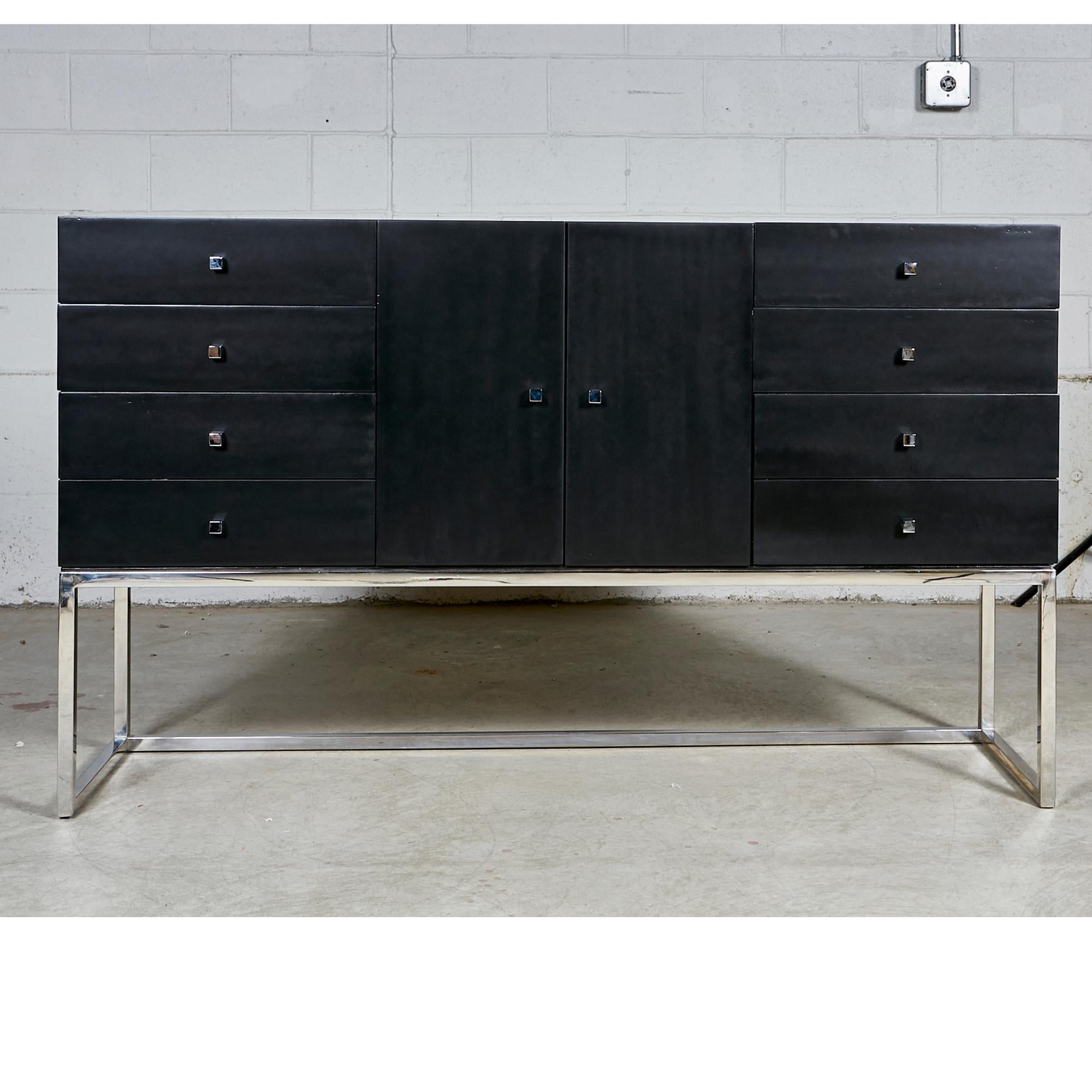 Vintage 1970s black painted credenza with a chrome base. The credenza has 8 drawers for storage and chrome pulls. In newly refinished condition. No maker's mark.
 