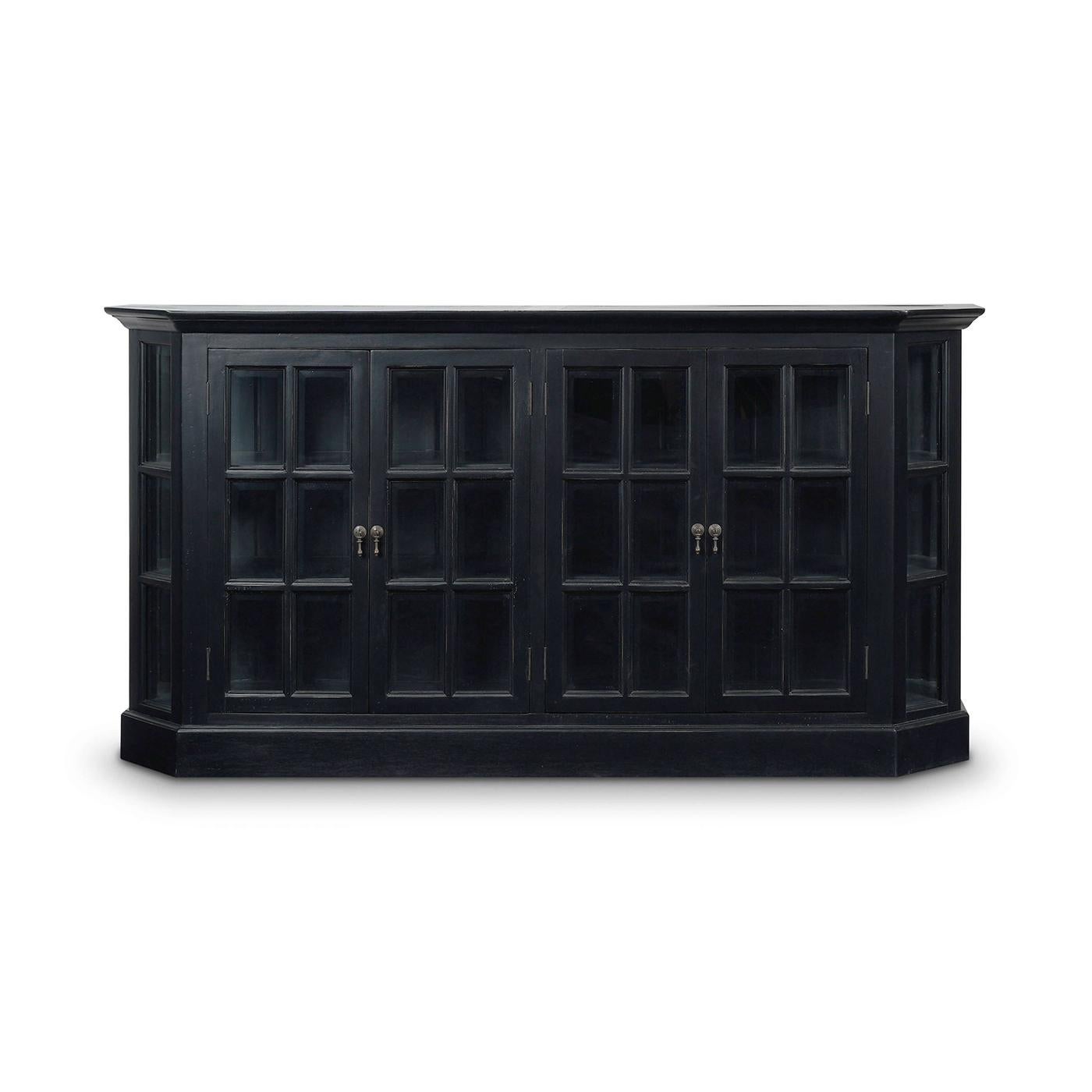 Featuring a batavia black finish to the exterior and interior. Crafted from solid mahogany, this cabinet exudes provincial elegance with its elegant. The canted corners and framed glass doors add a touch of sophistication while allowing a clear view