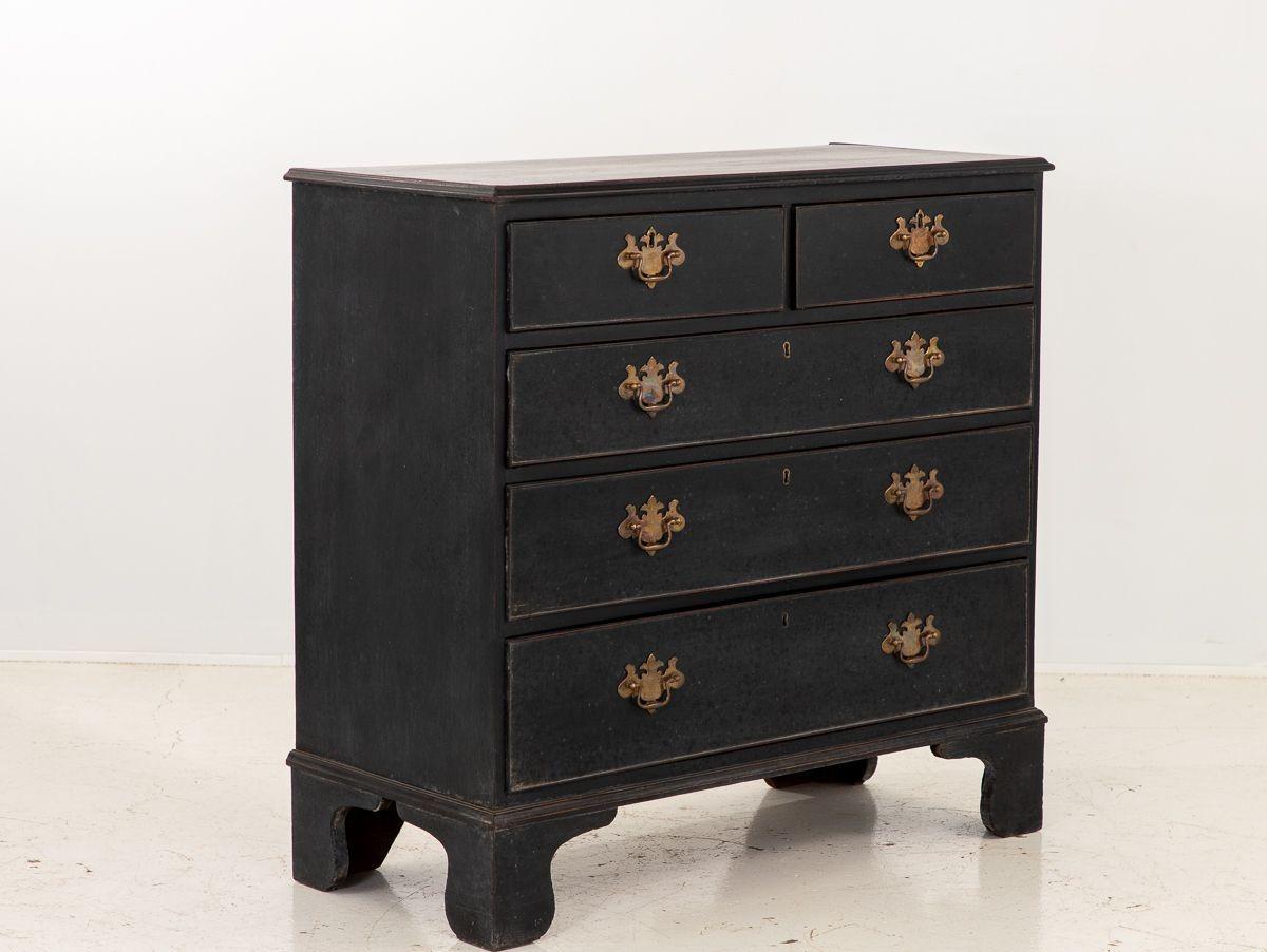 A black painted Georgian style dresser resting on four Ogee feet. This 19th century English dresser has a two over three drawer configuration. Brass pulls and escutcheon complete the look.