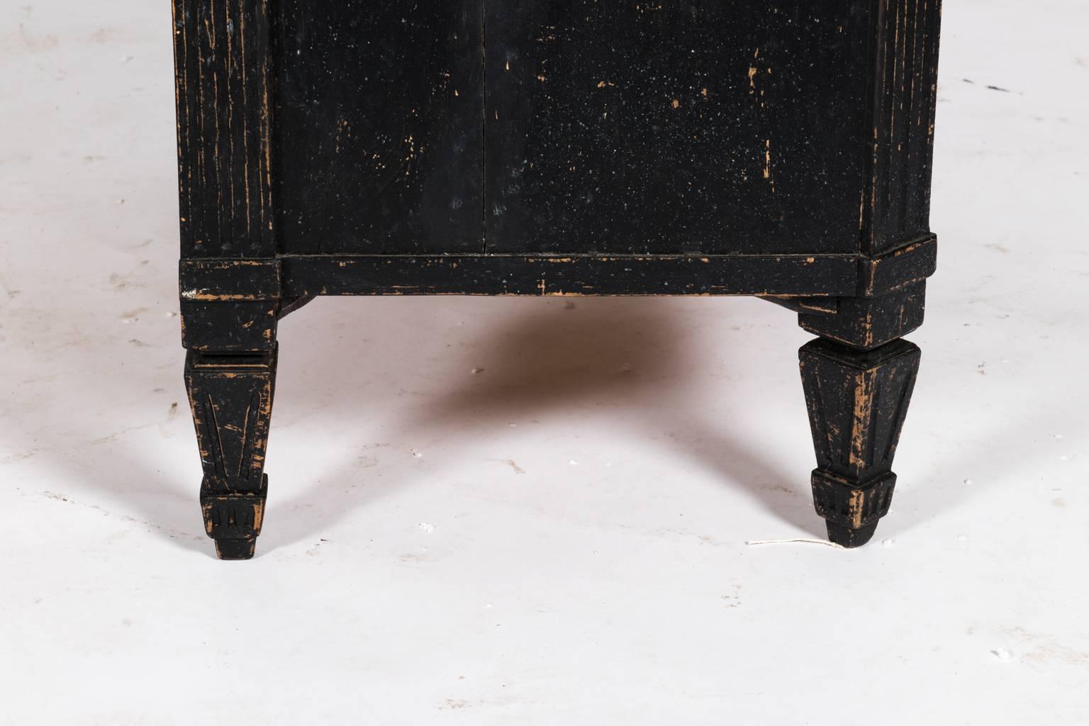 Pair of black painted three-drawer Gustavian style dressers with turned legs, circa 19th century.
 
