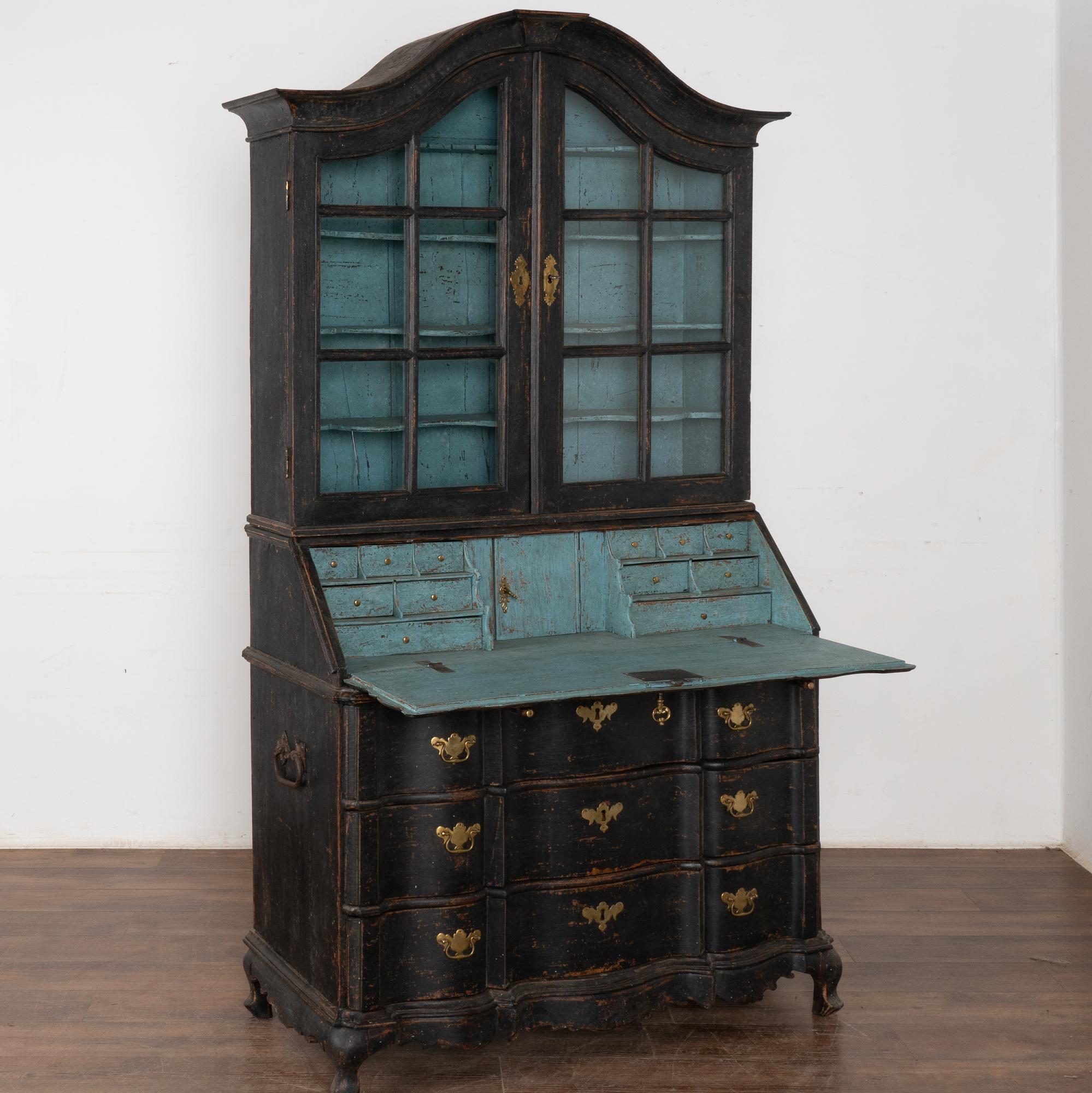 This striking oak secretary is an elegant statement piece with a lovely curved bonnet and pane glass upper section.
Large curvaceous lower three serpentine drawers.
The entire secretary has been given a professional custom layered black painted
