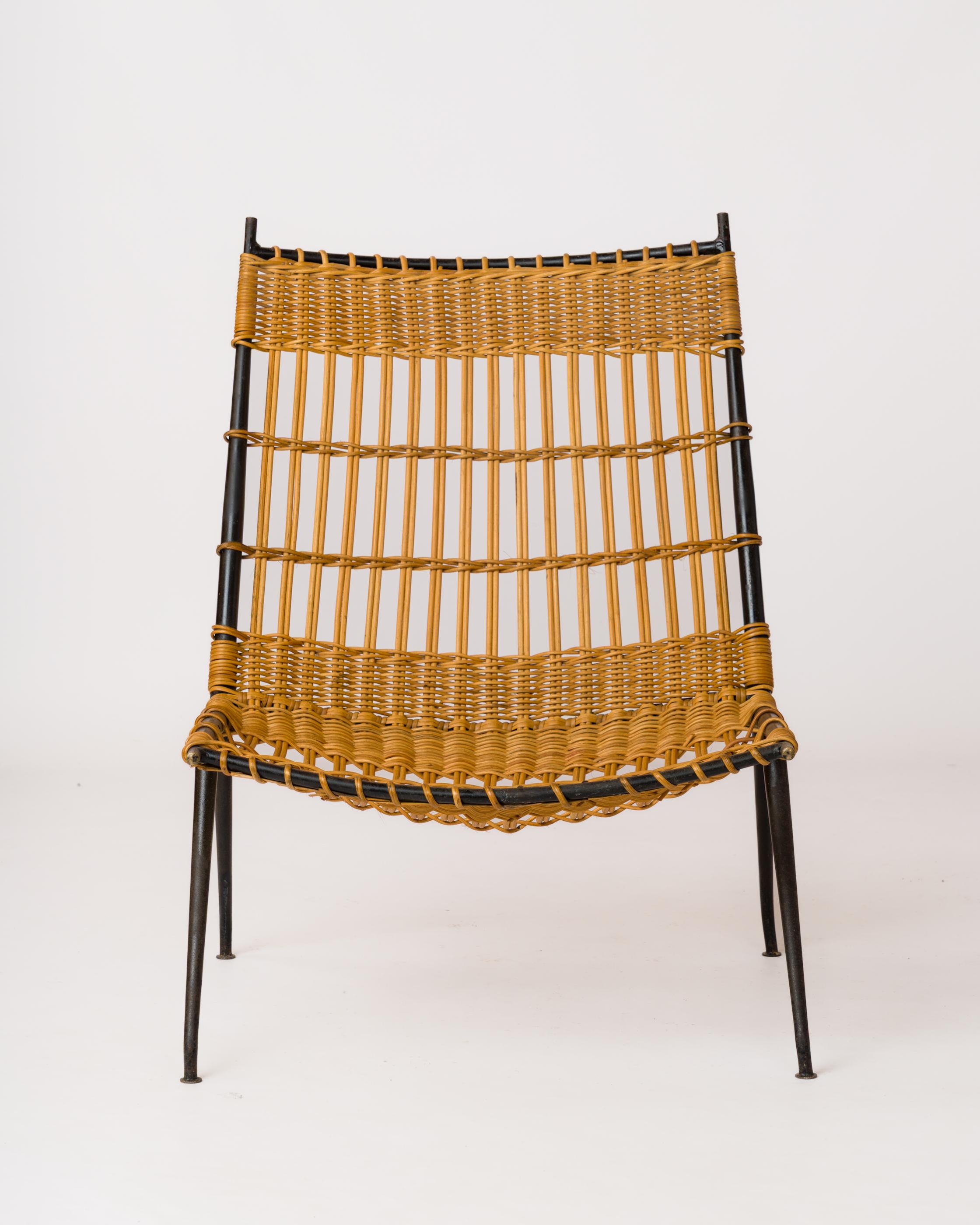 Black lacquered steel tube and woven rattan fireside 