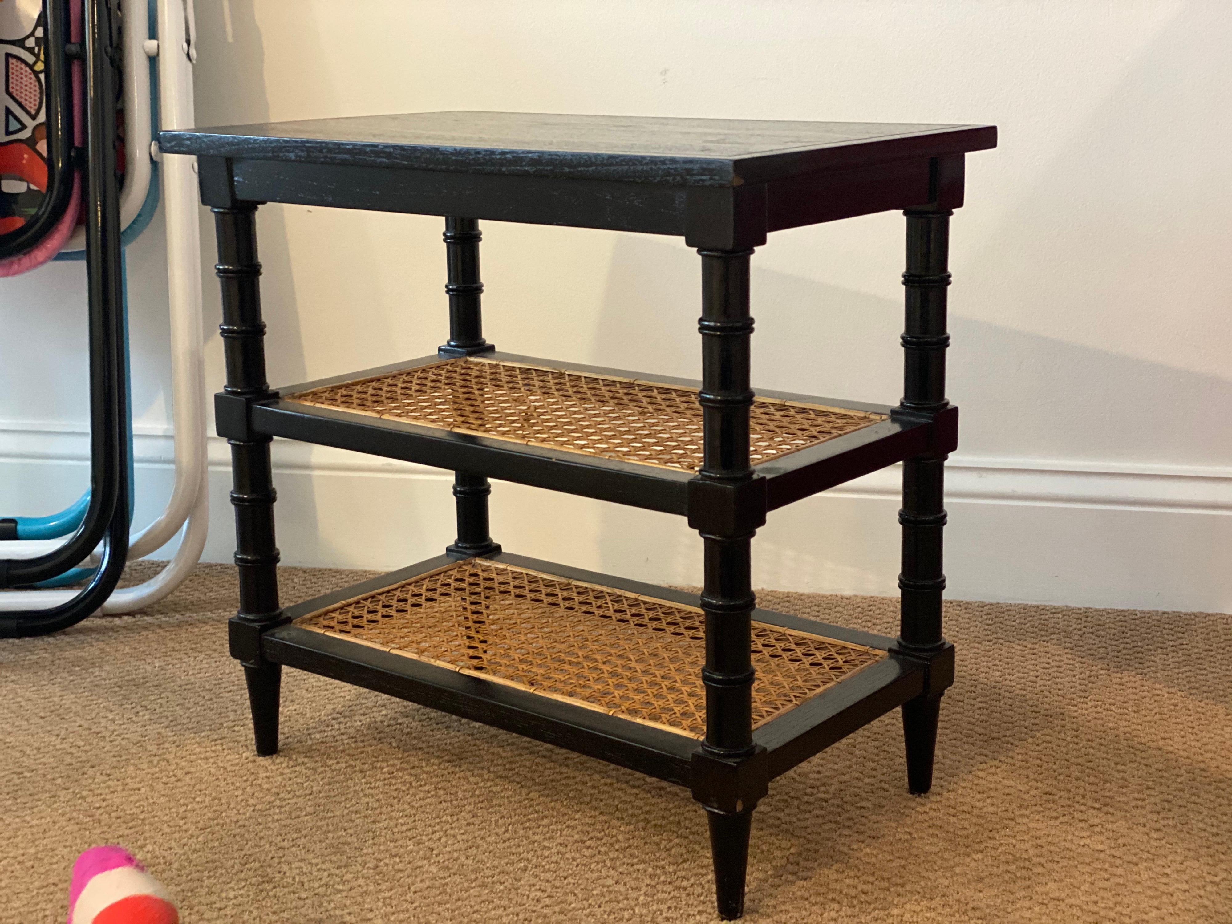 Black painted telephone end table with caned shelves
Bamboo style legs, caned shelves. 
Minor scratches to top finish.
Measures: 18