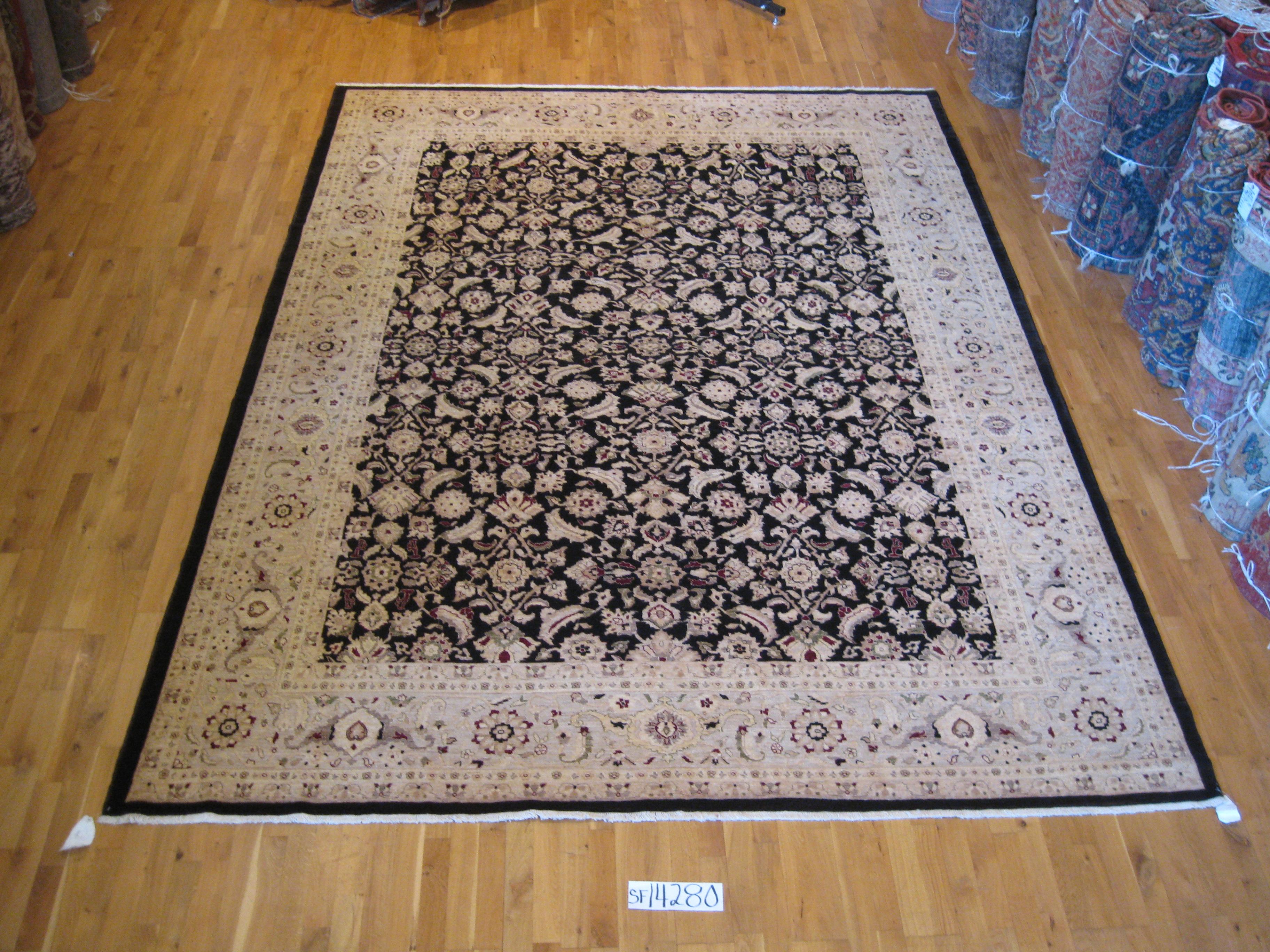 An elegant and graceful example of a traditional style rug featuring an intricately woven floral design against a large center panel and wide border frame. Durable all wool construction. Hand knotted in Pakistan.