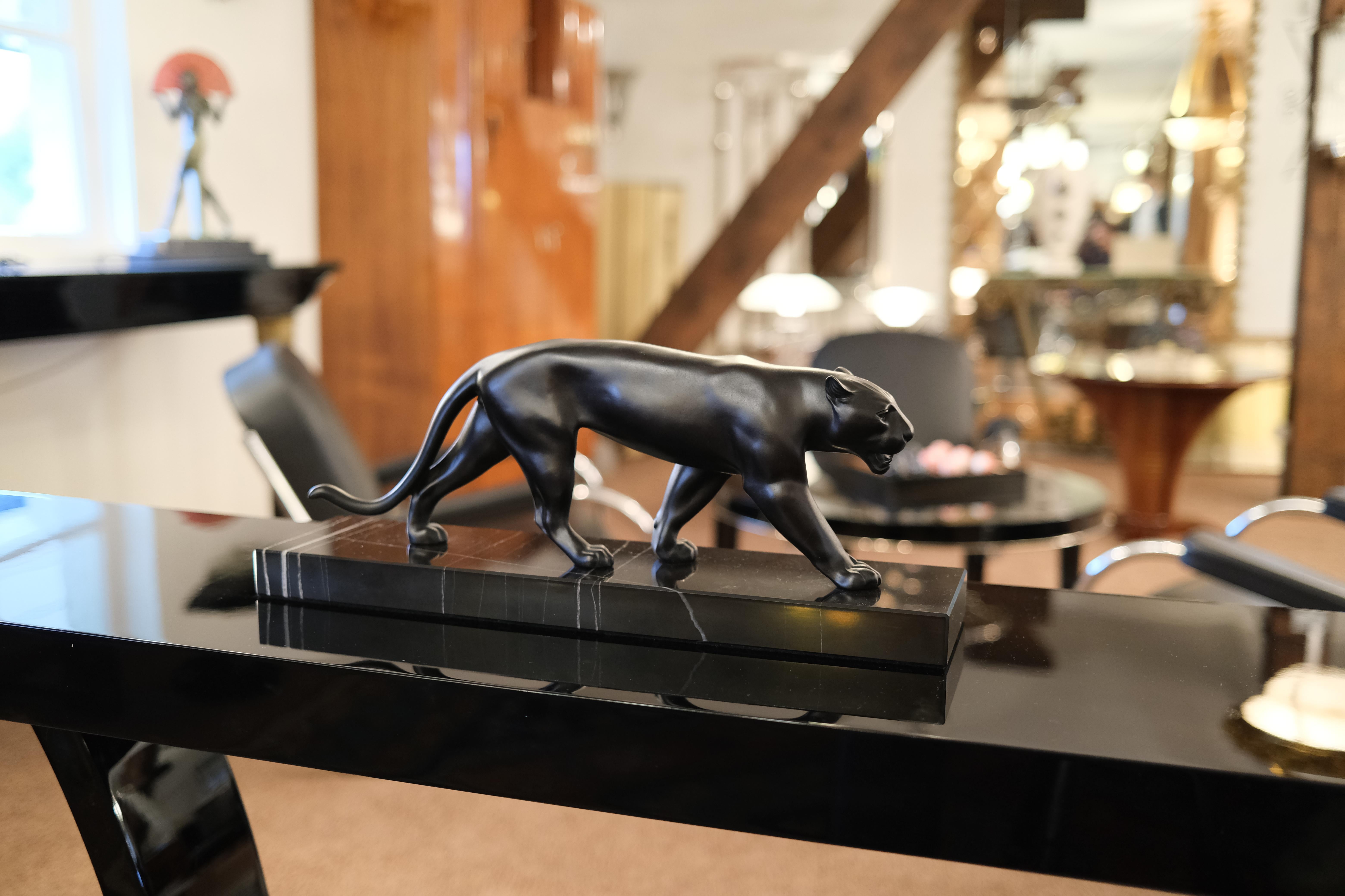 Lion or panther sculpture named “Ouganda”
Original “Max Le Verrier”, signed
Designed in France by “Max Le Verrier” (1891-1973) himself 
Art Deco style, France 

Materials: balck patinated spelter (French: régule), marble base
Socle could have