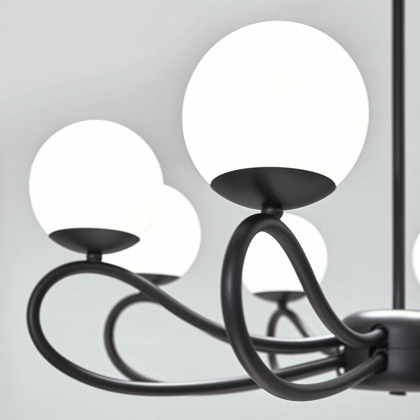 The fluid and artfully crafted metal tubes in this classy hanging light fixture are true to the name of the Papillon collection, which conjures up images of bowties. Designed by Matteo Zorzenoni, the metal elements are in a black matte finish, while