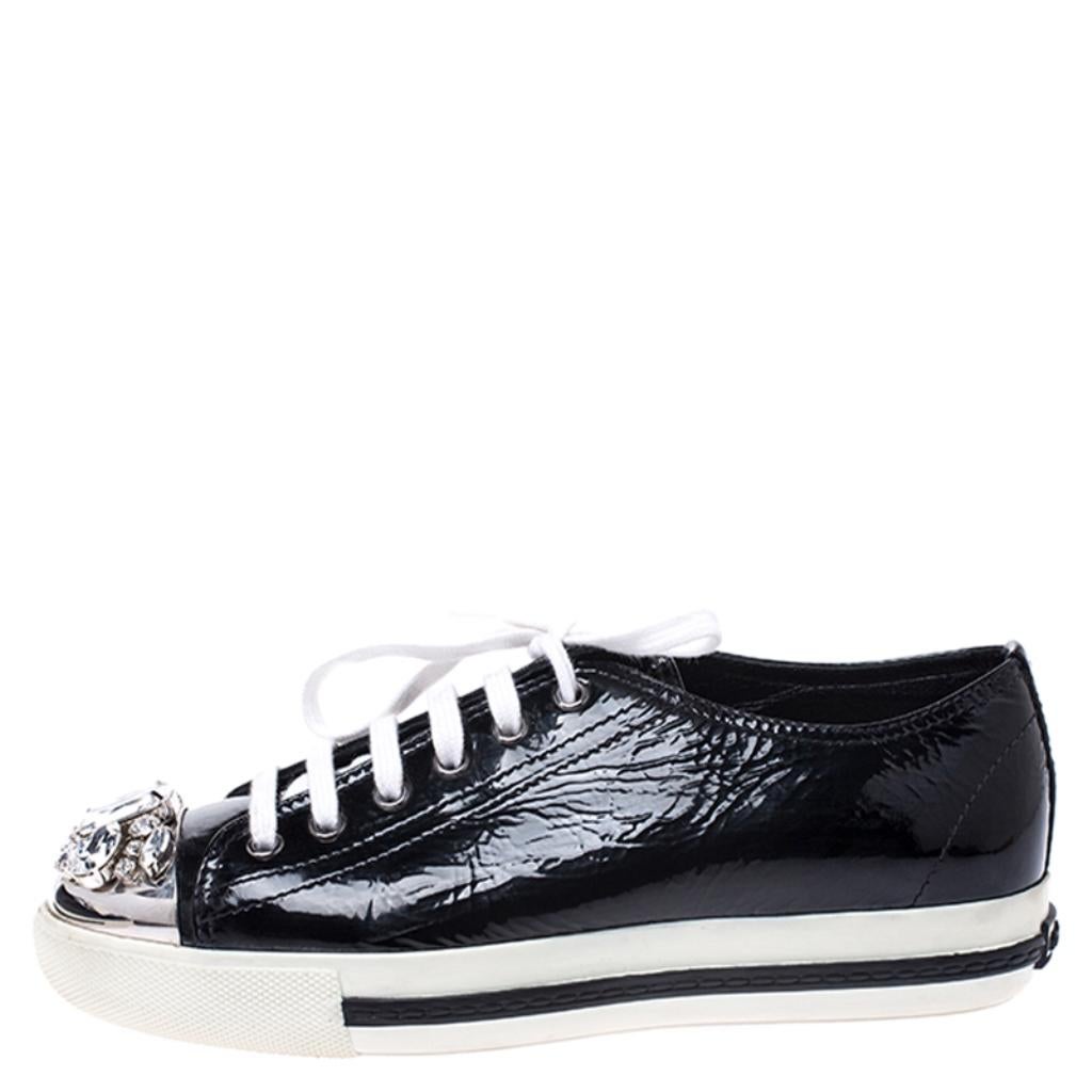These stunning sneakers by Miu Miu are a closet staple. Crafted from patent leather, they come in black. They feature lace-up fronts and cap toes embellished with crystals. They have leather lining, leather insoles and rubber soles that deliver