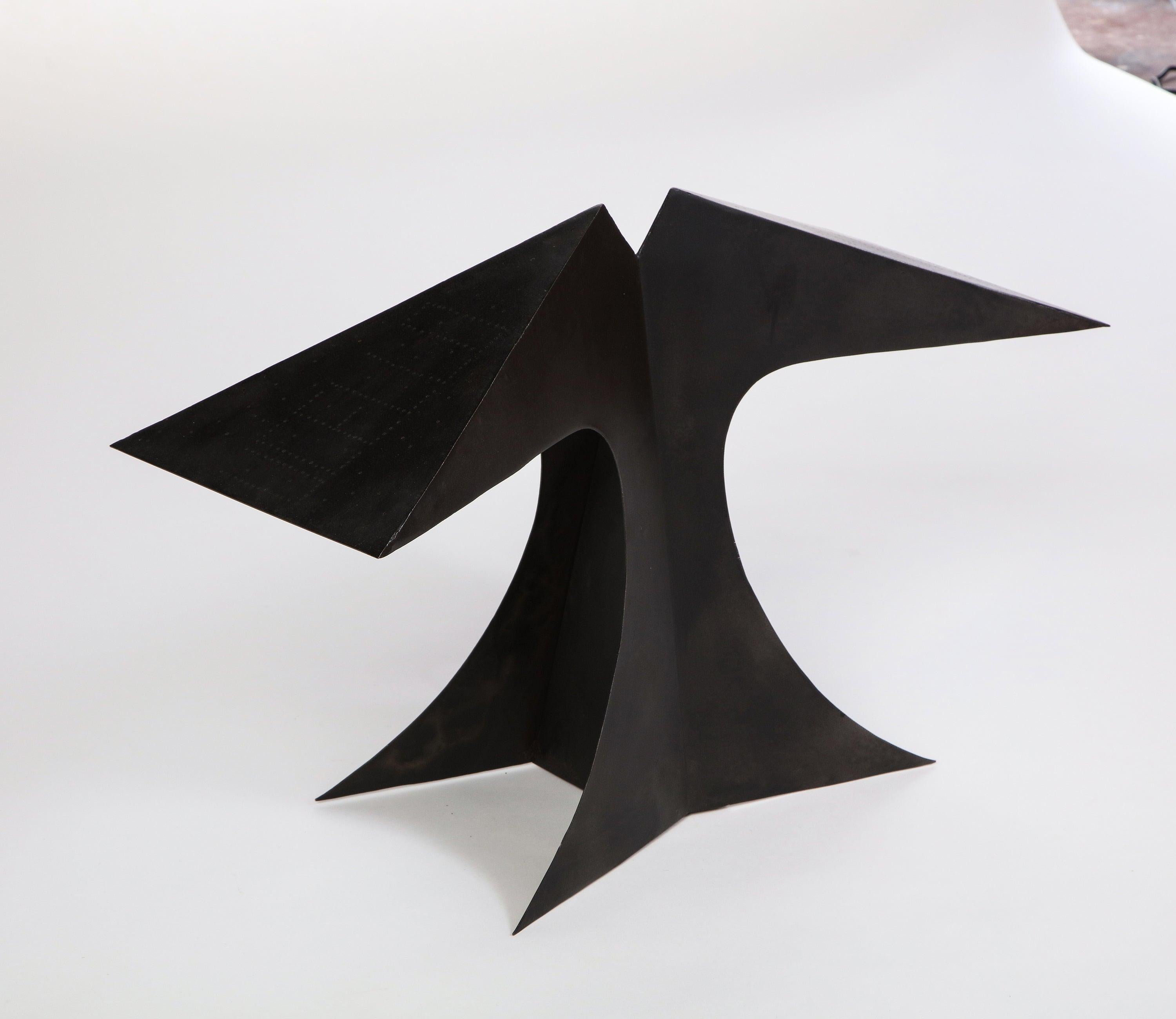 This sculptural 1970's Bernard Quentin black patinated and pierced-metal table lamp serves as a statement piece for any modernist living room. Its striking curves and angular lines make it an attractive companion for a side table or credenza. This