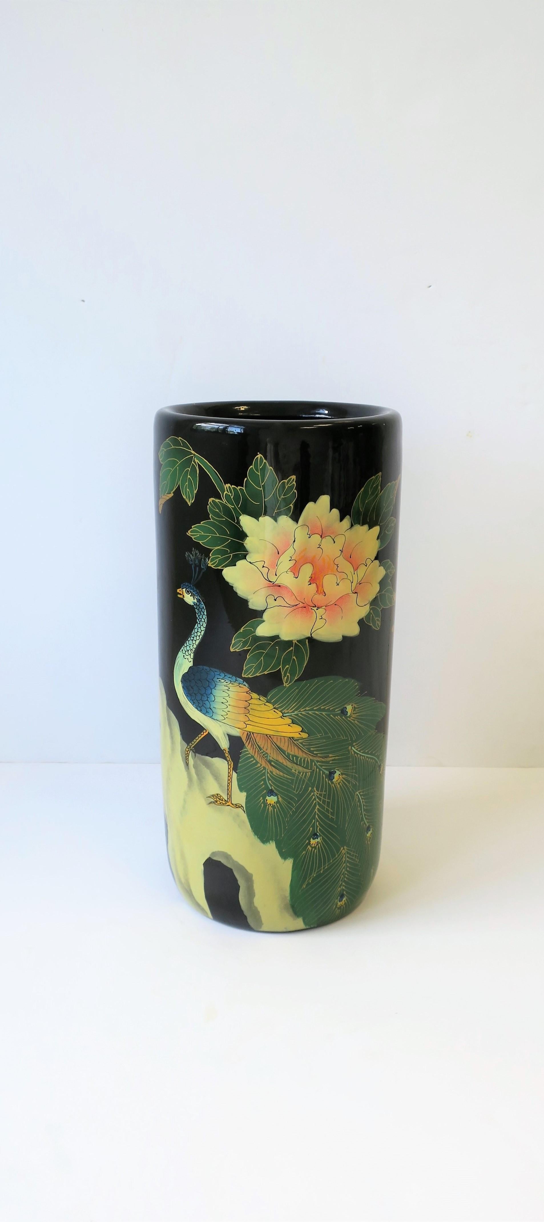 A beautiful umbrella stand with peacock birds, circa 1980s. Piece has beautiful decoration of peacock birds with elaborate tails, large red rose and pink flowers. Colors include: black, red, pink, blue, green, off-white, orange, and yellow. Piece