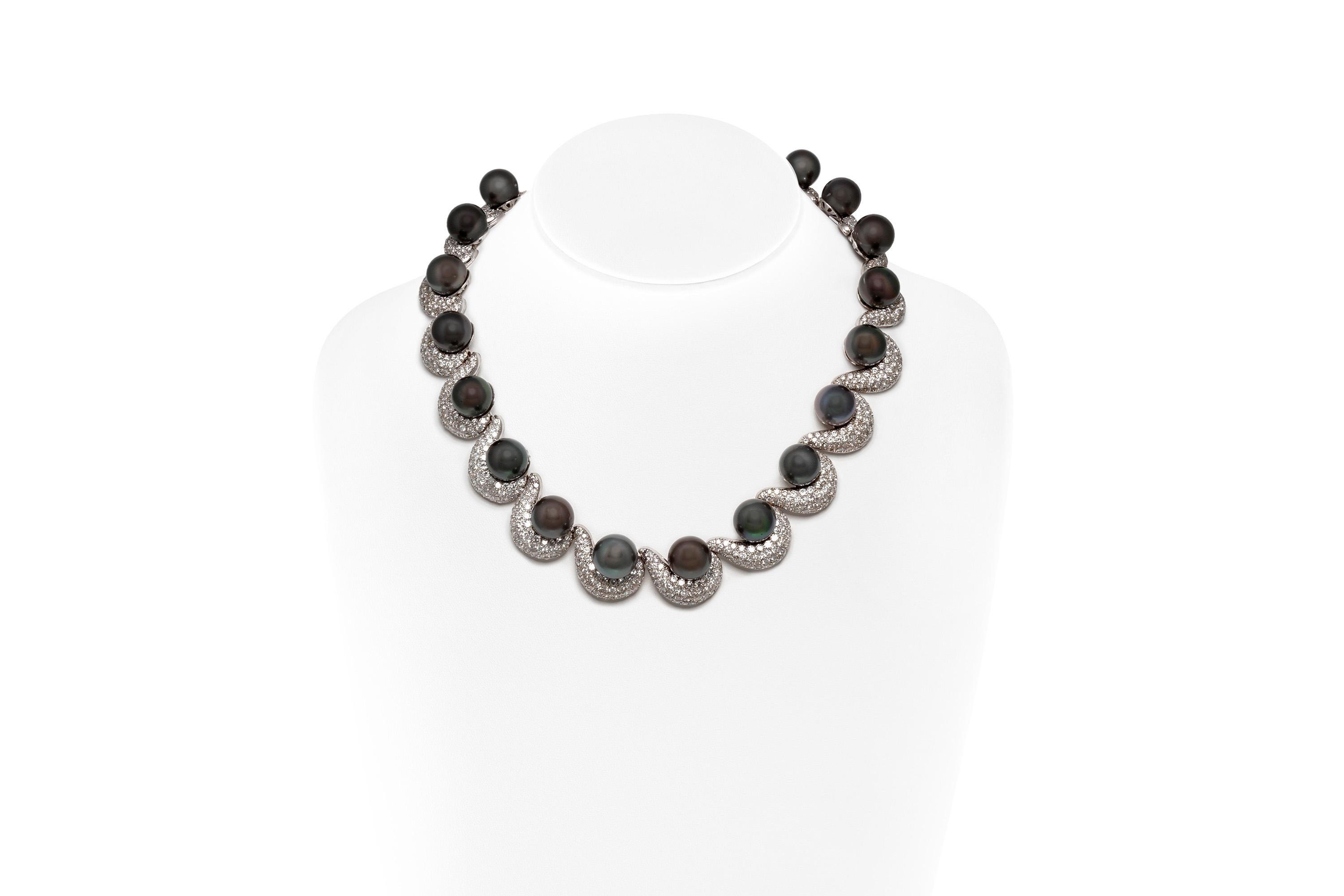 Necklace, finely crafted in 18k white gold with diamonds weighing approximately a total of 50.00 carats and black pearls.

