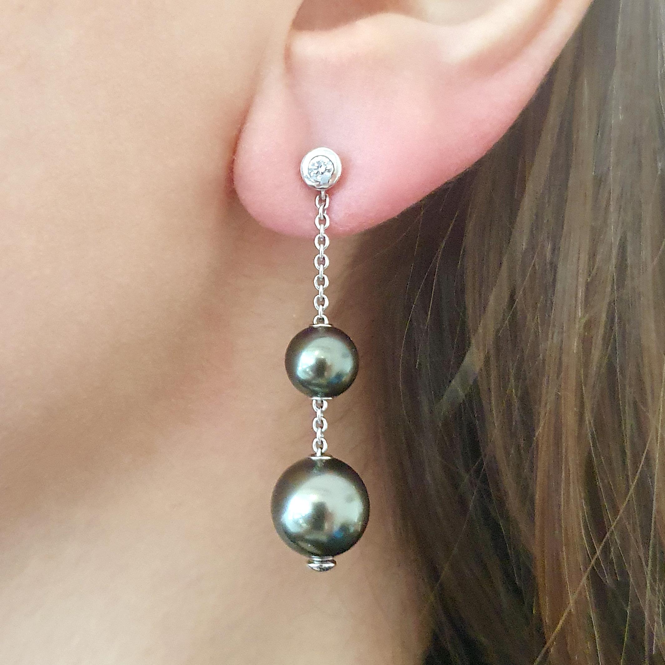 Four Black Pearls Earrings on white gold with small diamonds.
Contemporary.

Total weight: 7.57 grams.
Total height: 1.77 inch (4.50 centimeters).