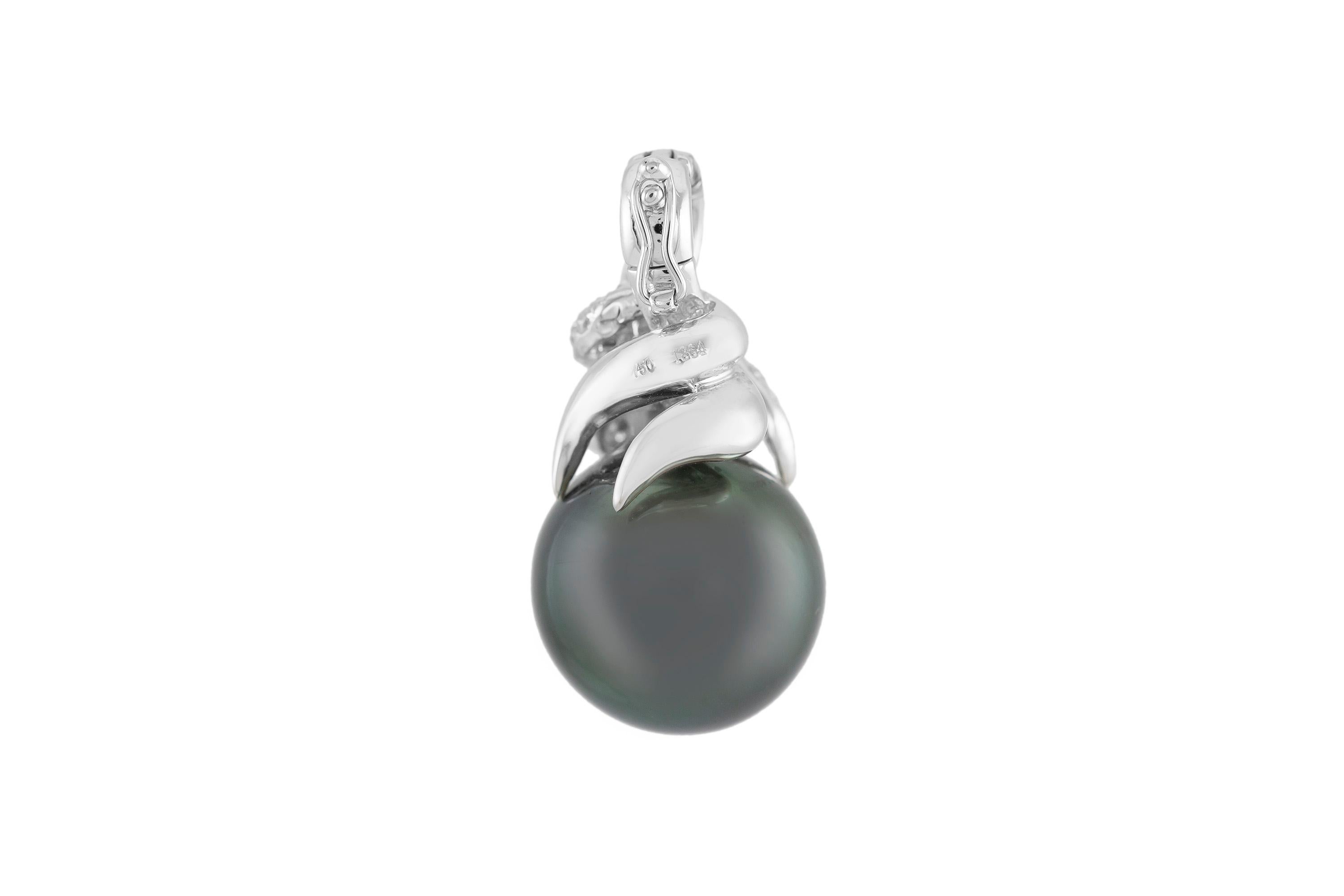Pendant finely crafted in 18k white gold, with a black pearl and diamonds weighing a total of of 0.38cts. Circa 1960.