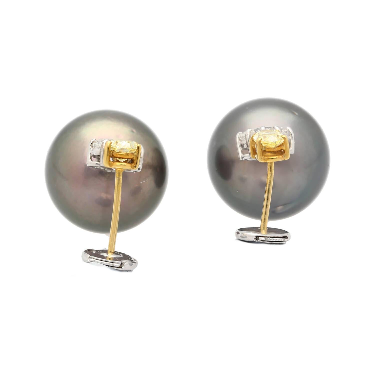 Natural 3.40 carat black pearl drop earrings set in 18K yellow and white gold with 0.94 carat fancy yellow and 1.49 carat white lily cut diamonds. Statement design with push-back closure.

Details:
Item Type: Drop Earrings
Metal: 18K Yellow and