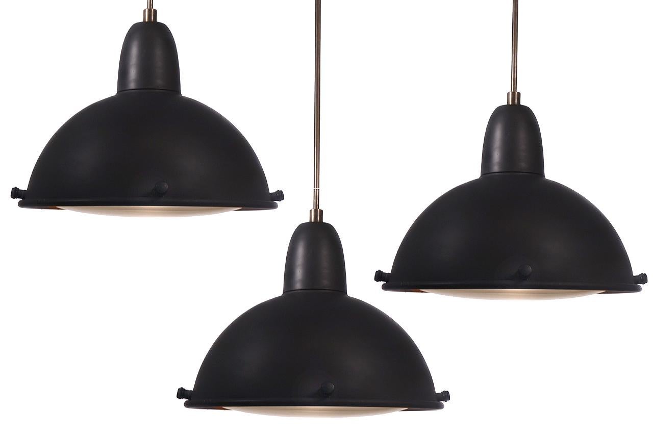 We were able to acquire a nice collection of these large impressive pendants. These were custom-made for a large Times Square restaurant that closed. They are substantial with heavy gauge spun dome and a cast brass top. The heavy spun shade has a 16