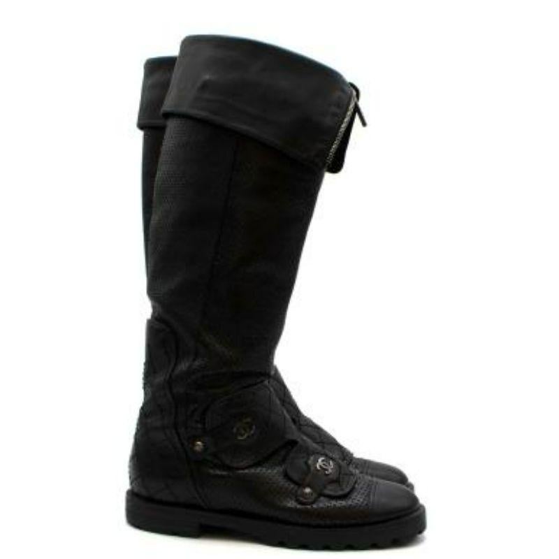 Chanel black perforated leather long biker boots
 
 
 
 - Sturdy black leather with rubber grip sole
 
 - Diamond quilting on heel panel and fold-over panel
 
 - Plain leather toe cap
 
 - Brushed silver logos and logo decorative buttons
 
 - Extra