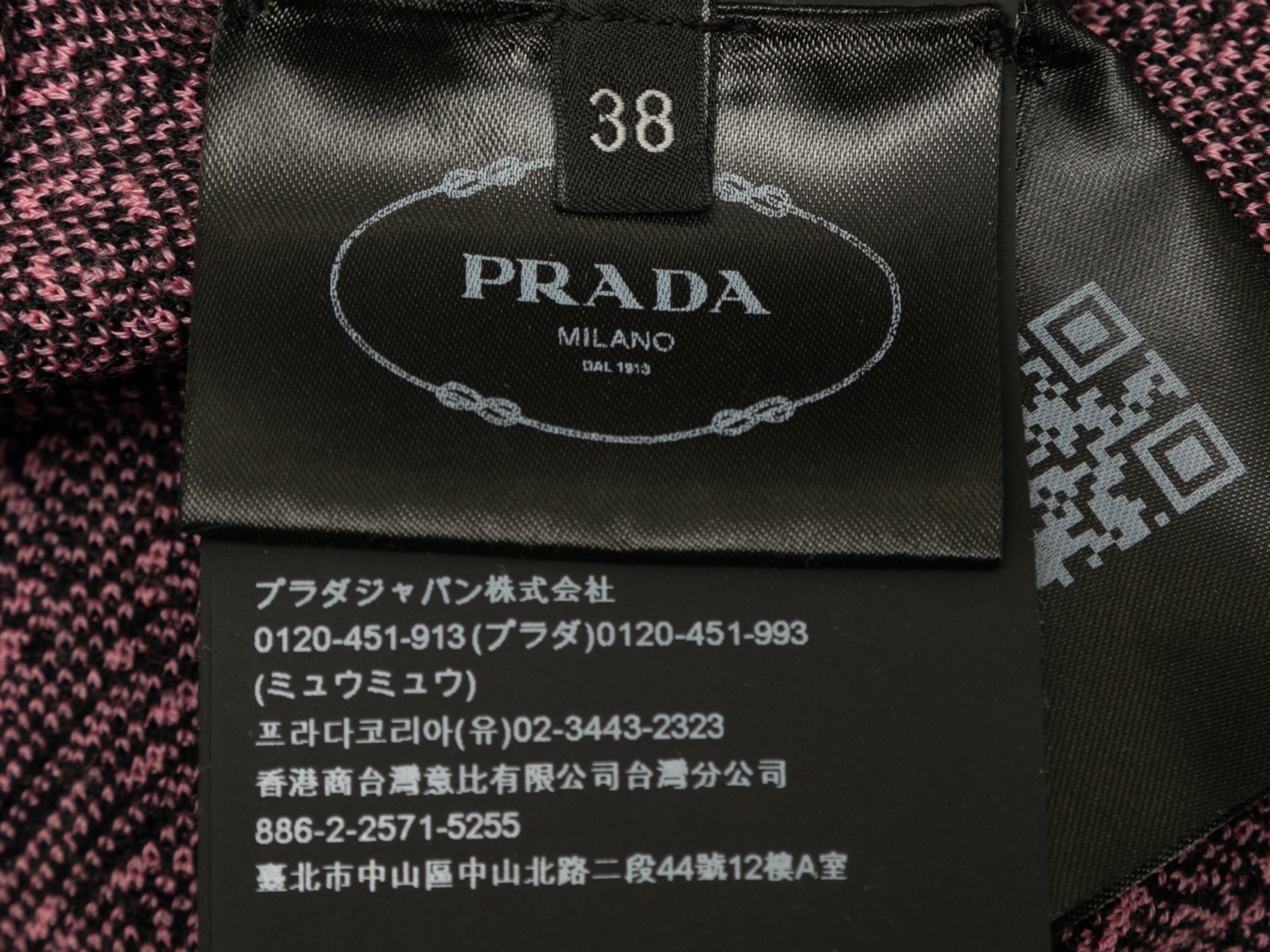 Black and pink virgin wool bodycon jumpsuit by Prada. Circa 2021. Abstract pattern throughout. Mock neck. Long sleeves. Zip closure at back. 33