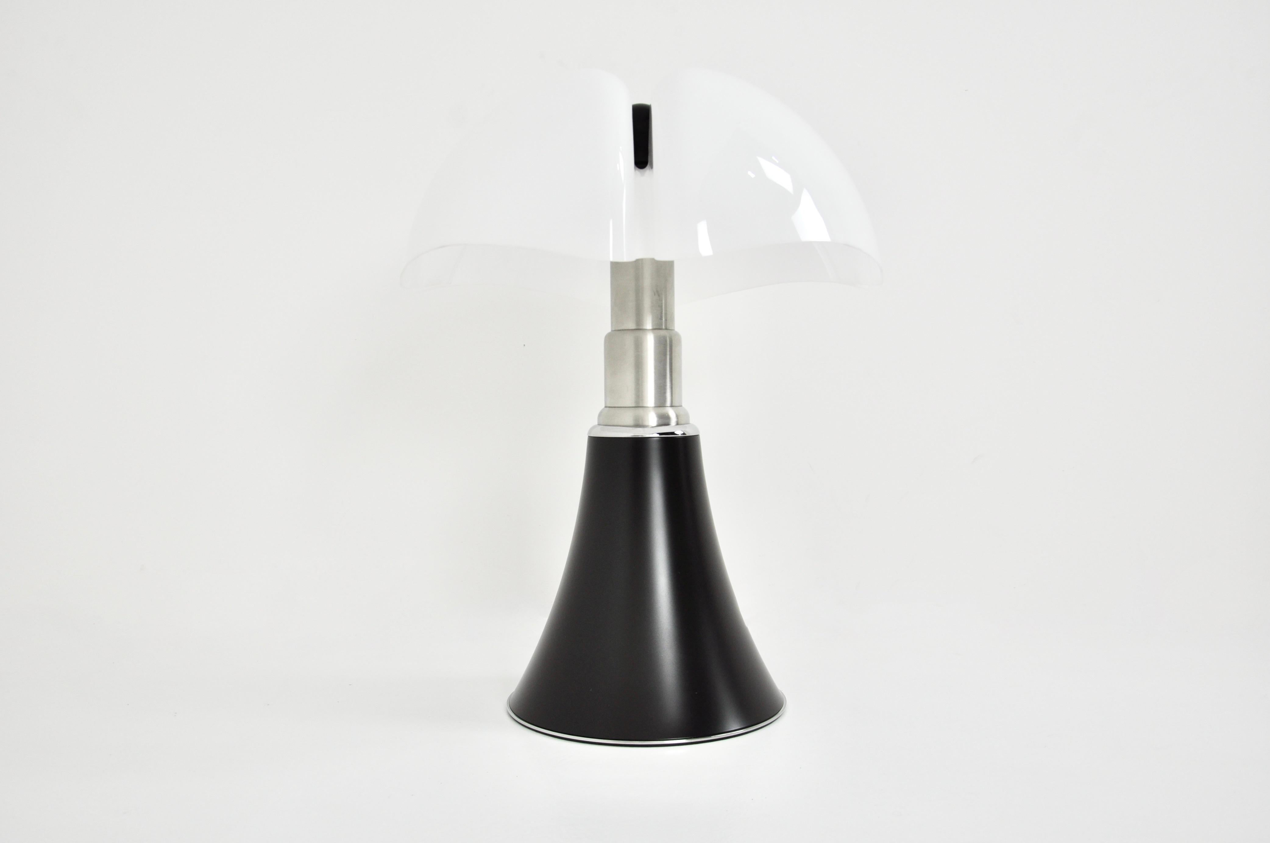 Black lamp in metal and plastic by Gae Aulenti. Adjustable in height min: 70cm max: 90cm 
Stamped under the lamp.
